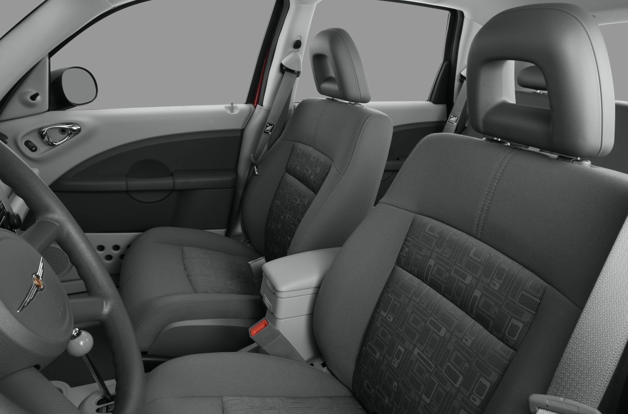 Close-up of fabric front seats and dashboard steering area