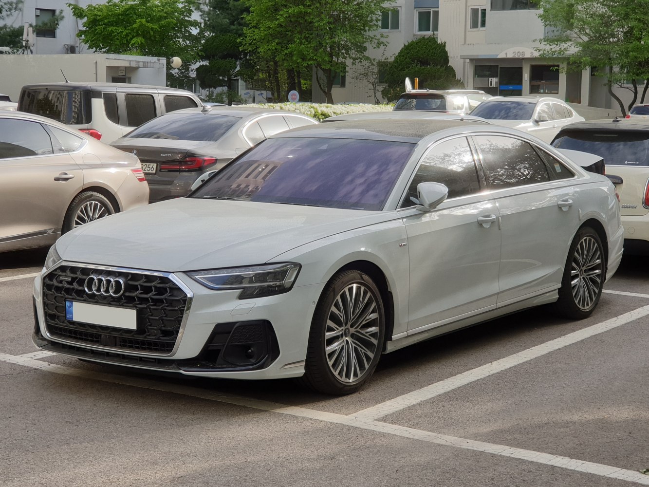 Luxury sedan with large hexagonal grille and alloy wheels.