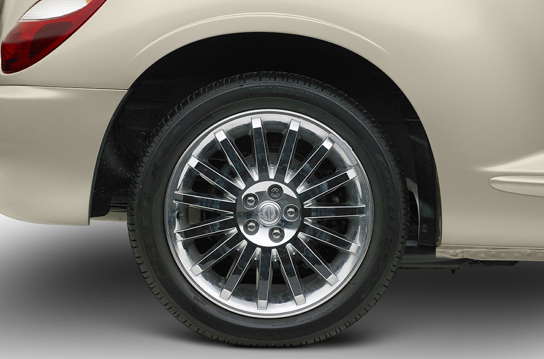 Chrome multi-spoke wheel with beige rear fender