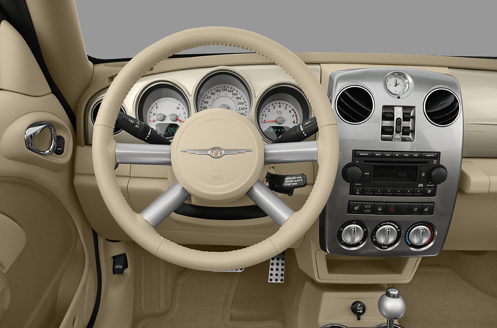 Beige dashboard with steering wheel, analog gauges, and center control panel