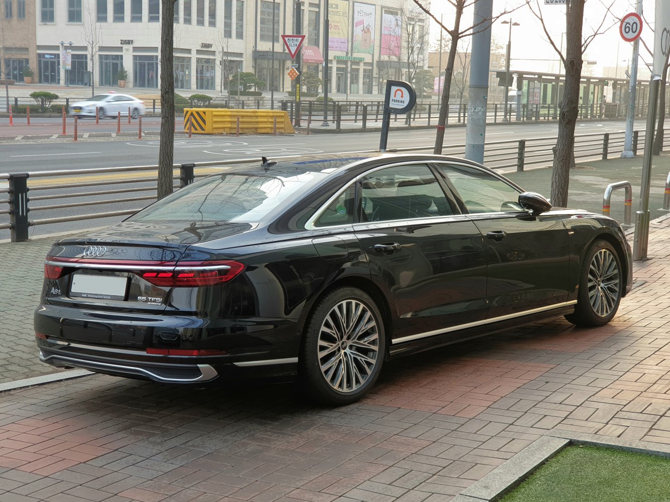 Rear side view of luxury sedan with distinct tail lights and premium alloy wheels