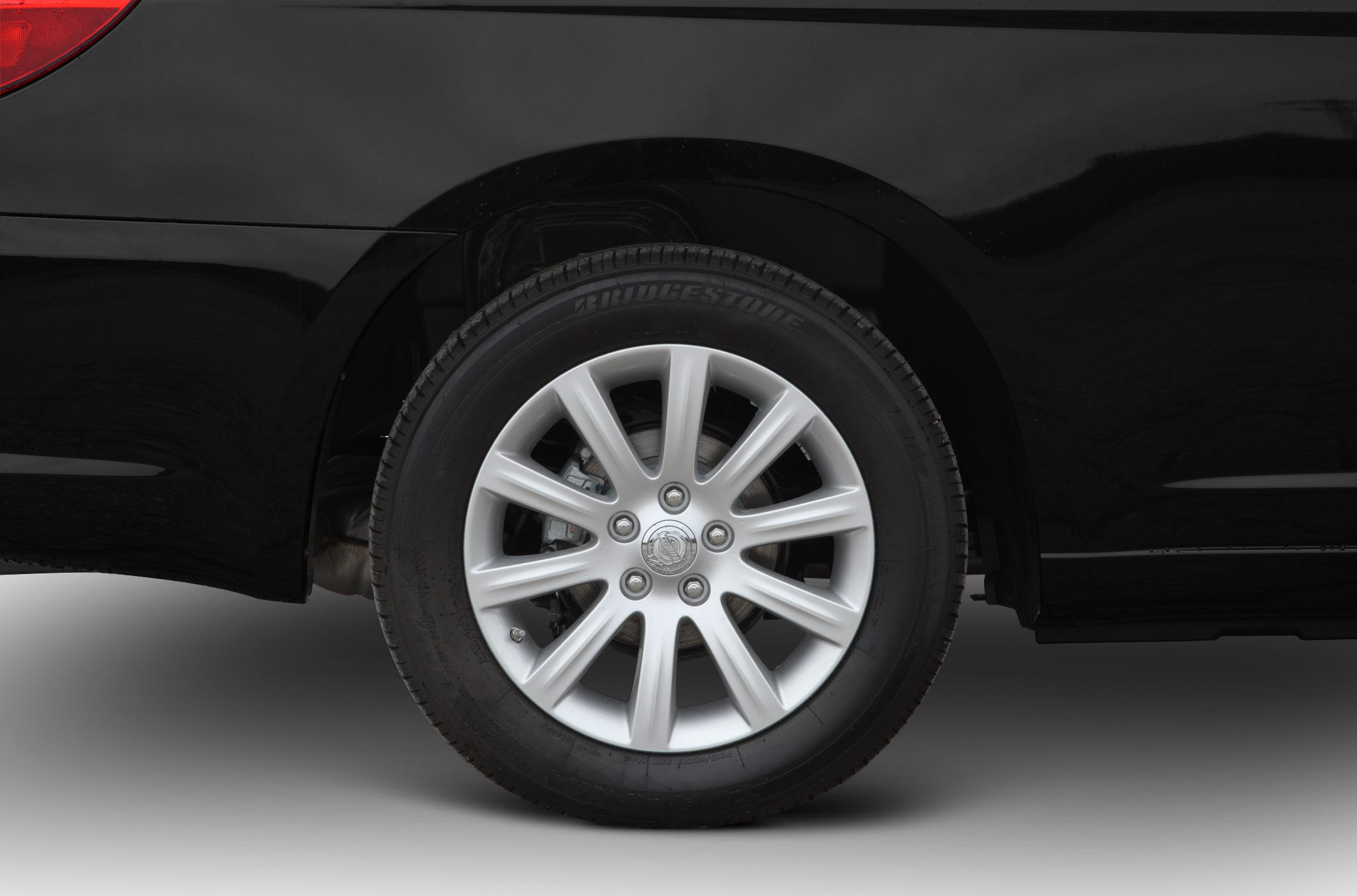 Close-up of alloy wheel and tire on a vehicle side panel
