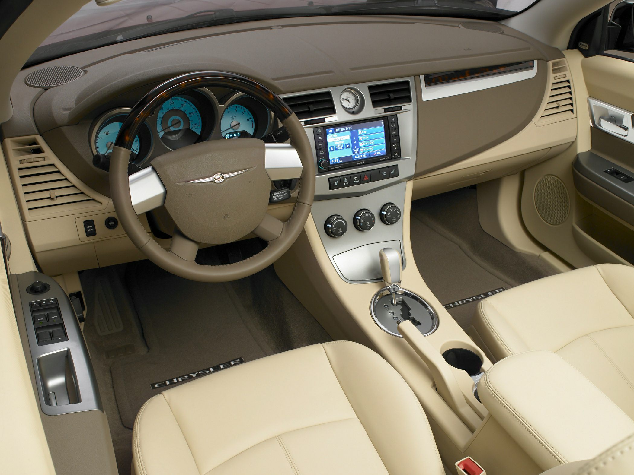 Beige car interior with dashboard, analog clock, and multimedia display