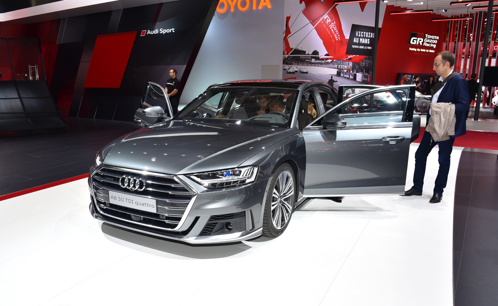 Luxury sedan front view with open doors and visible interior