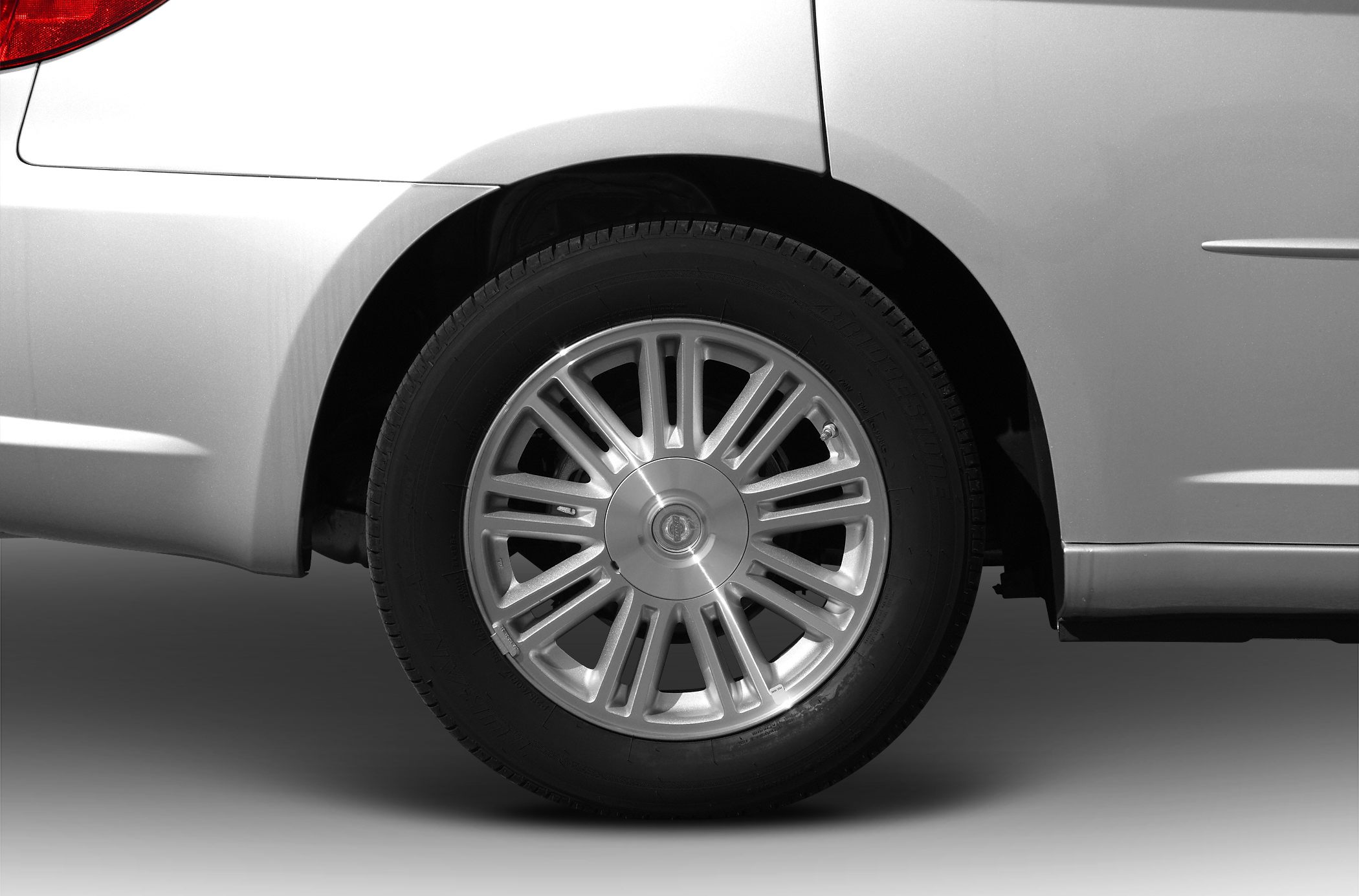Close-up of rear wheel alloy rim and car fender