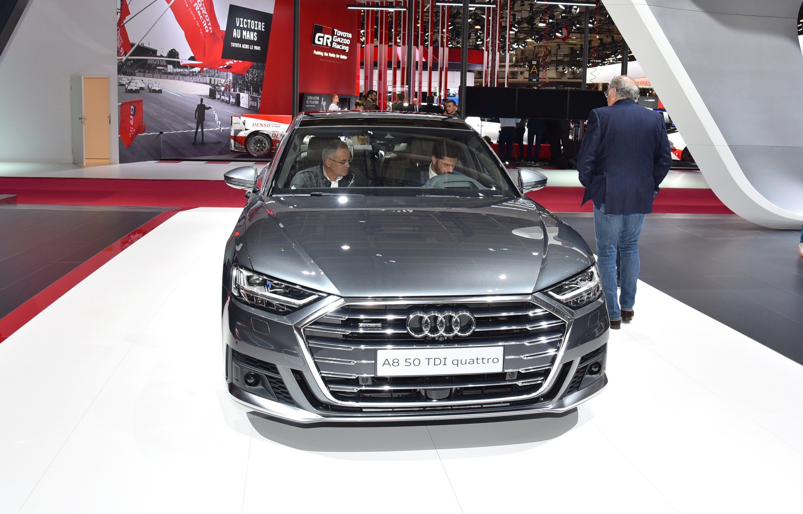 Front view of luxury sedan with LED headlights and prominent grille