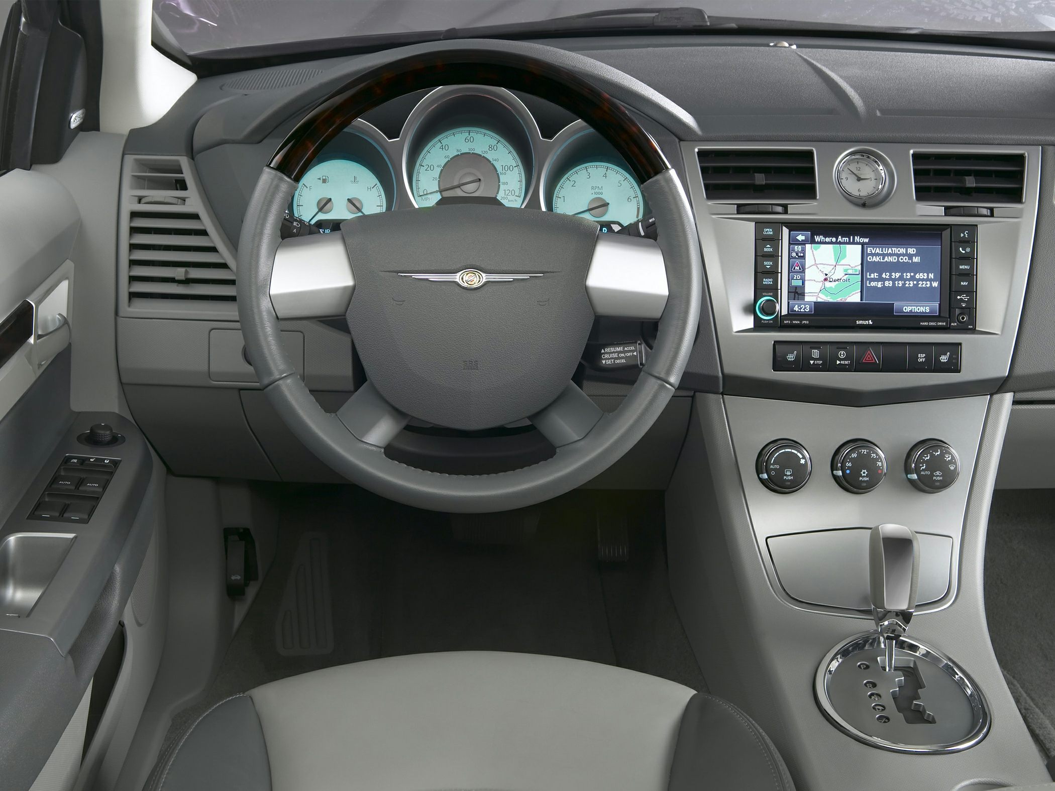 Steering wheel, dashboard with digital gauges, and navigation system display