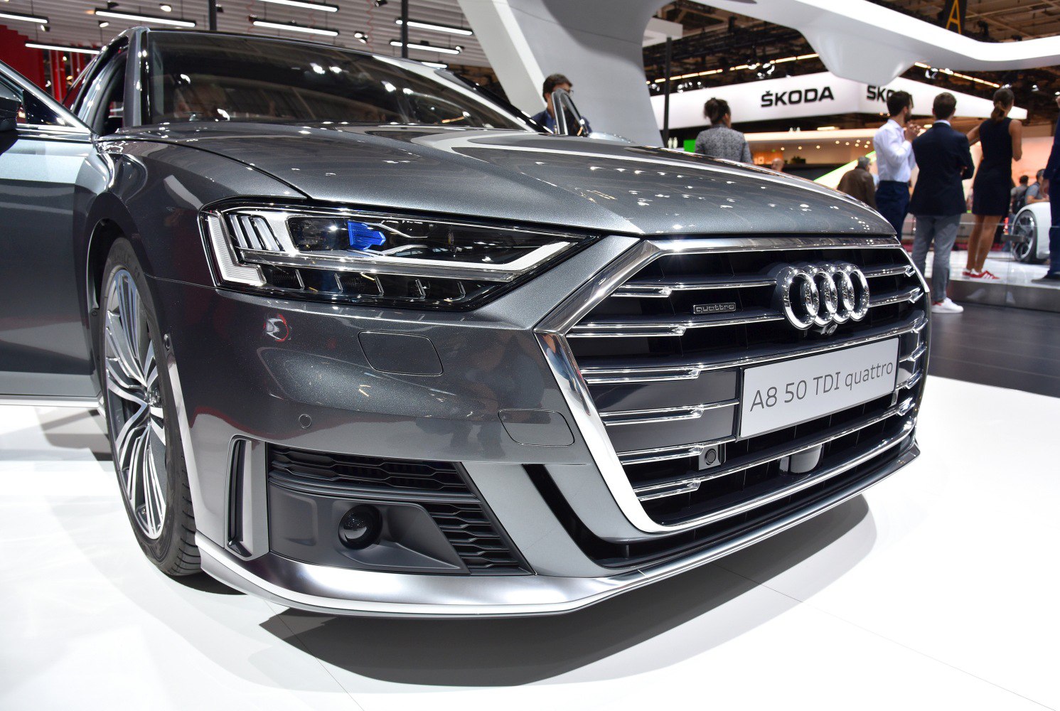 Front view close-up of a luxury sedan with distinctive grille and LED headlight.