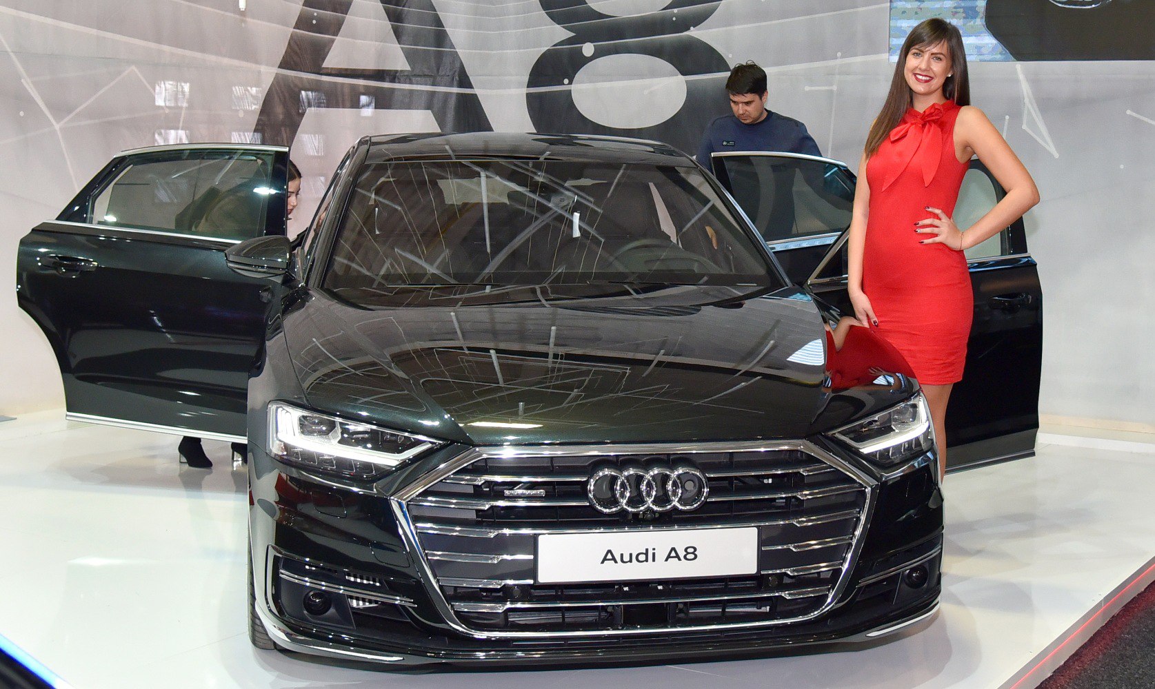 Front view of luxury sedan with open doors and LED headlights