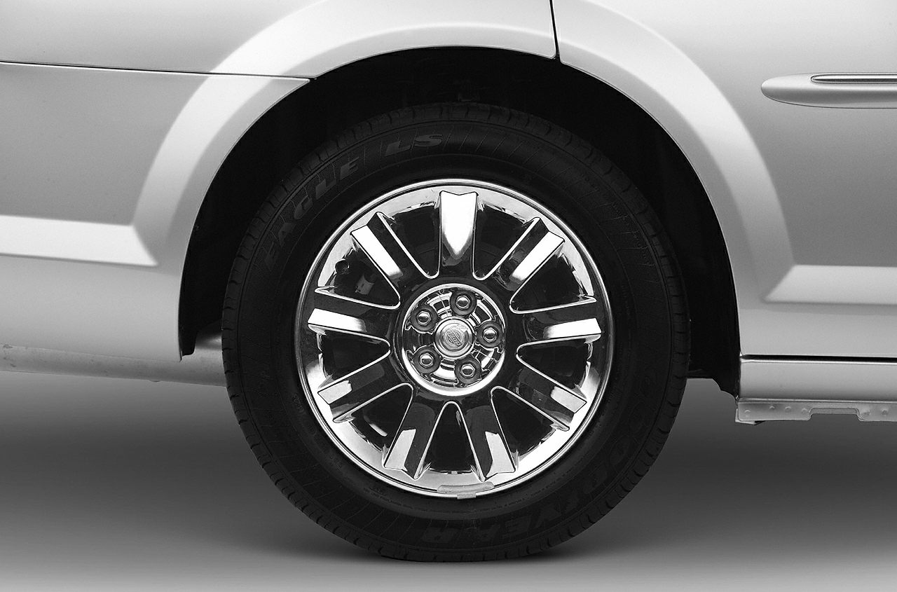 Close-up of a chrome alloy wheel with detailed spoke design and tire tread