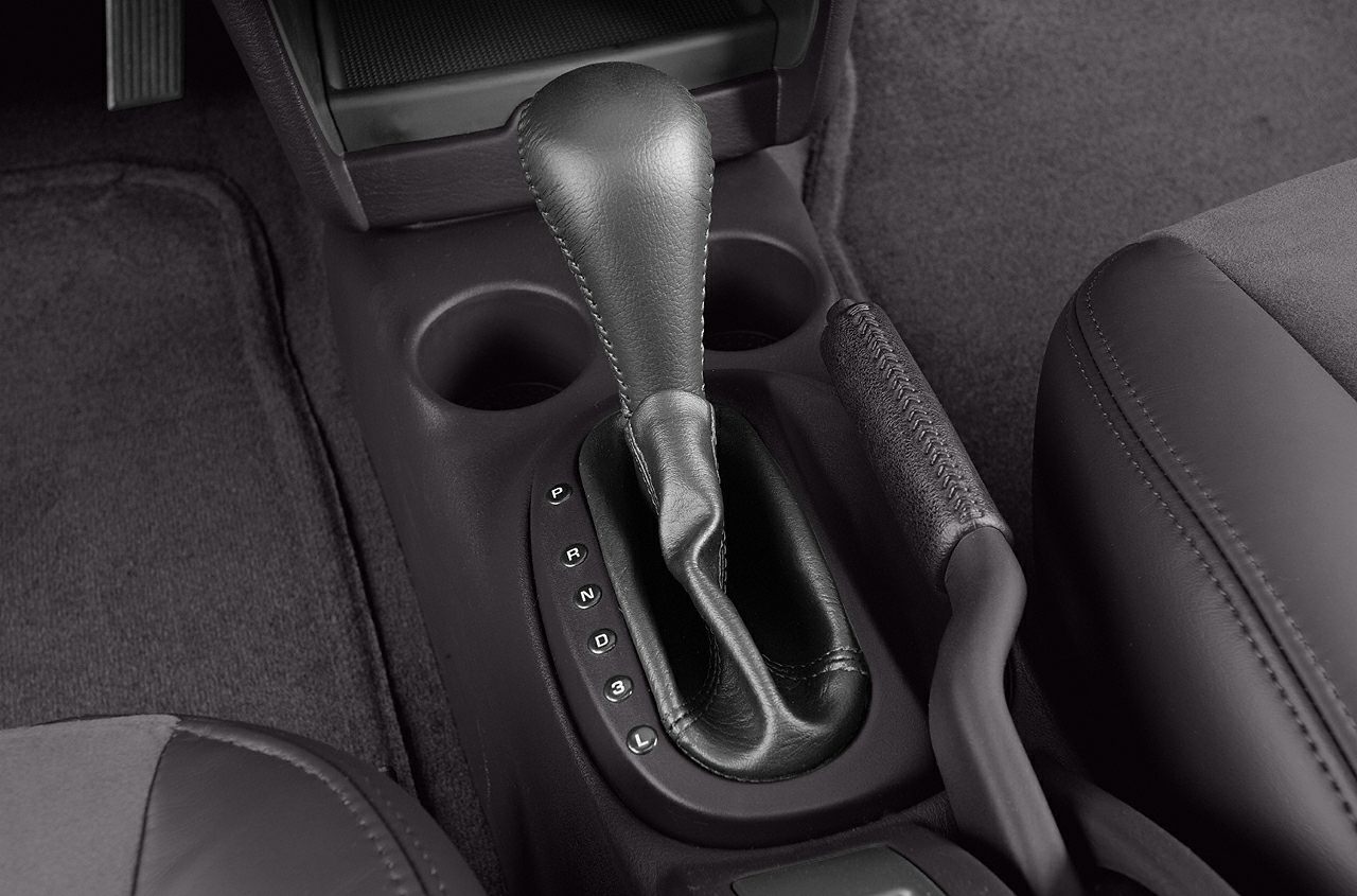 Automatic gear shifter and handbrake with cup holders in car interior