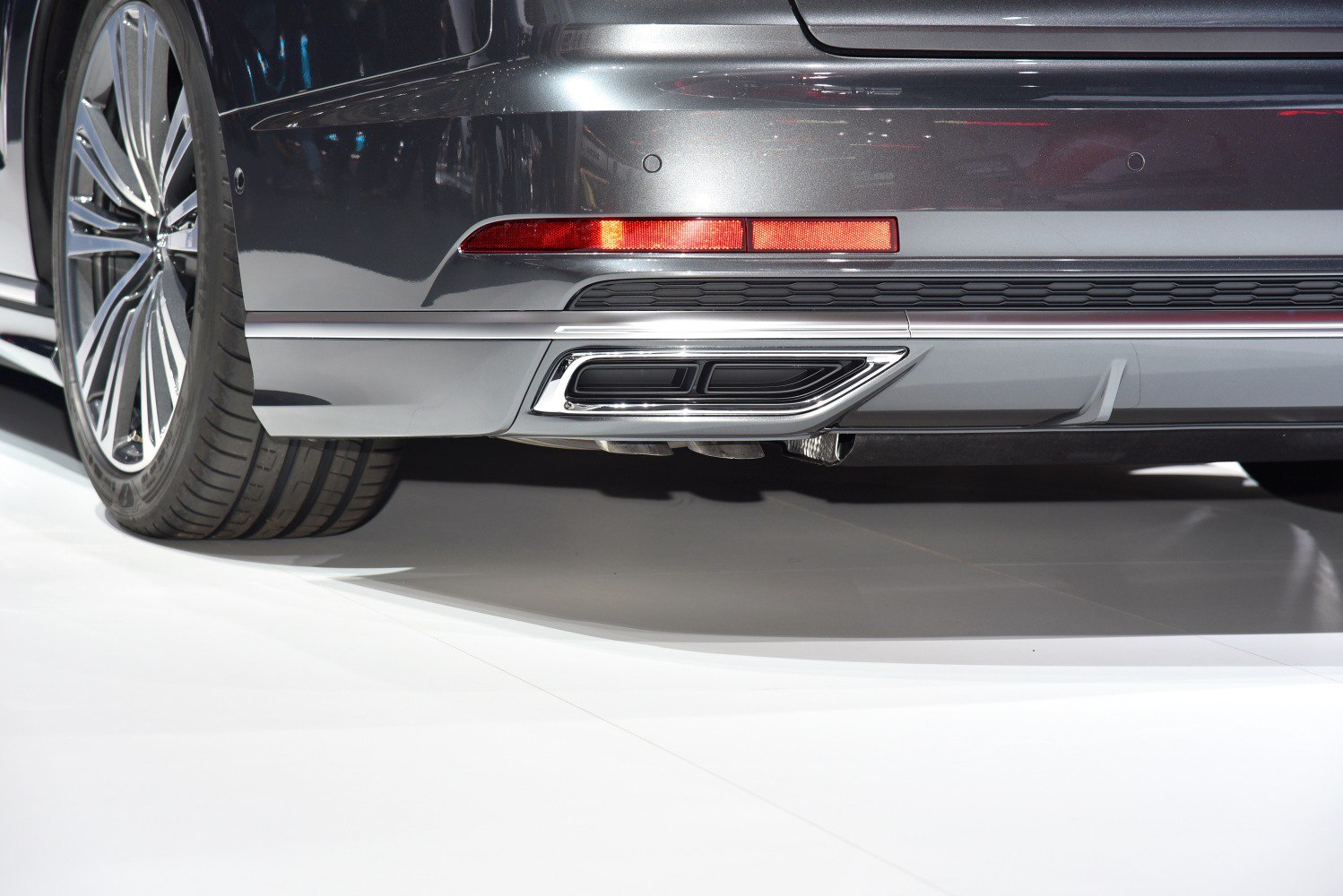 Close-up of rear exhaust and wheel on luxury sedan