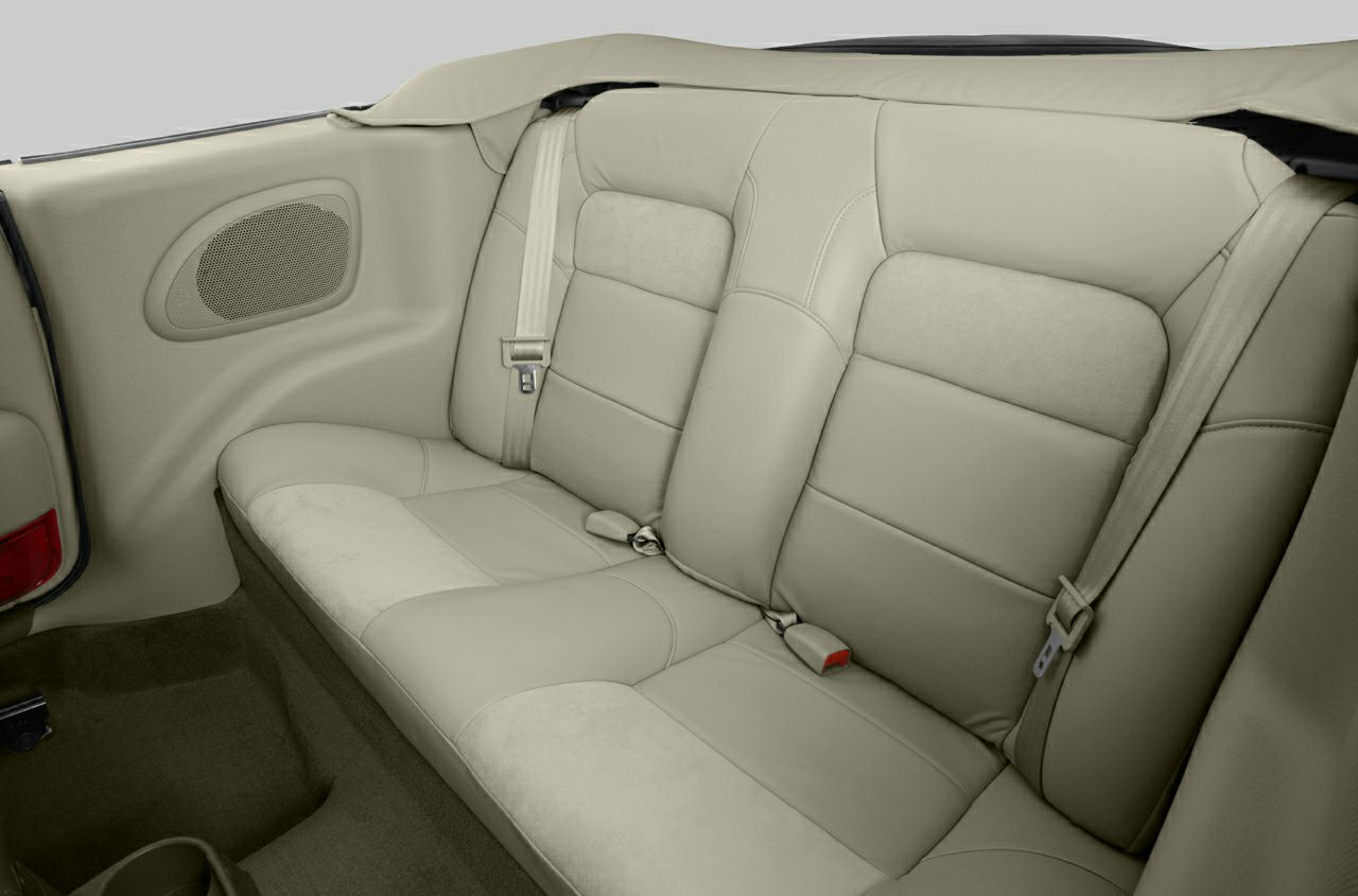 Rear beige leather seats with integrated seat belts in a convertible
