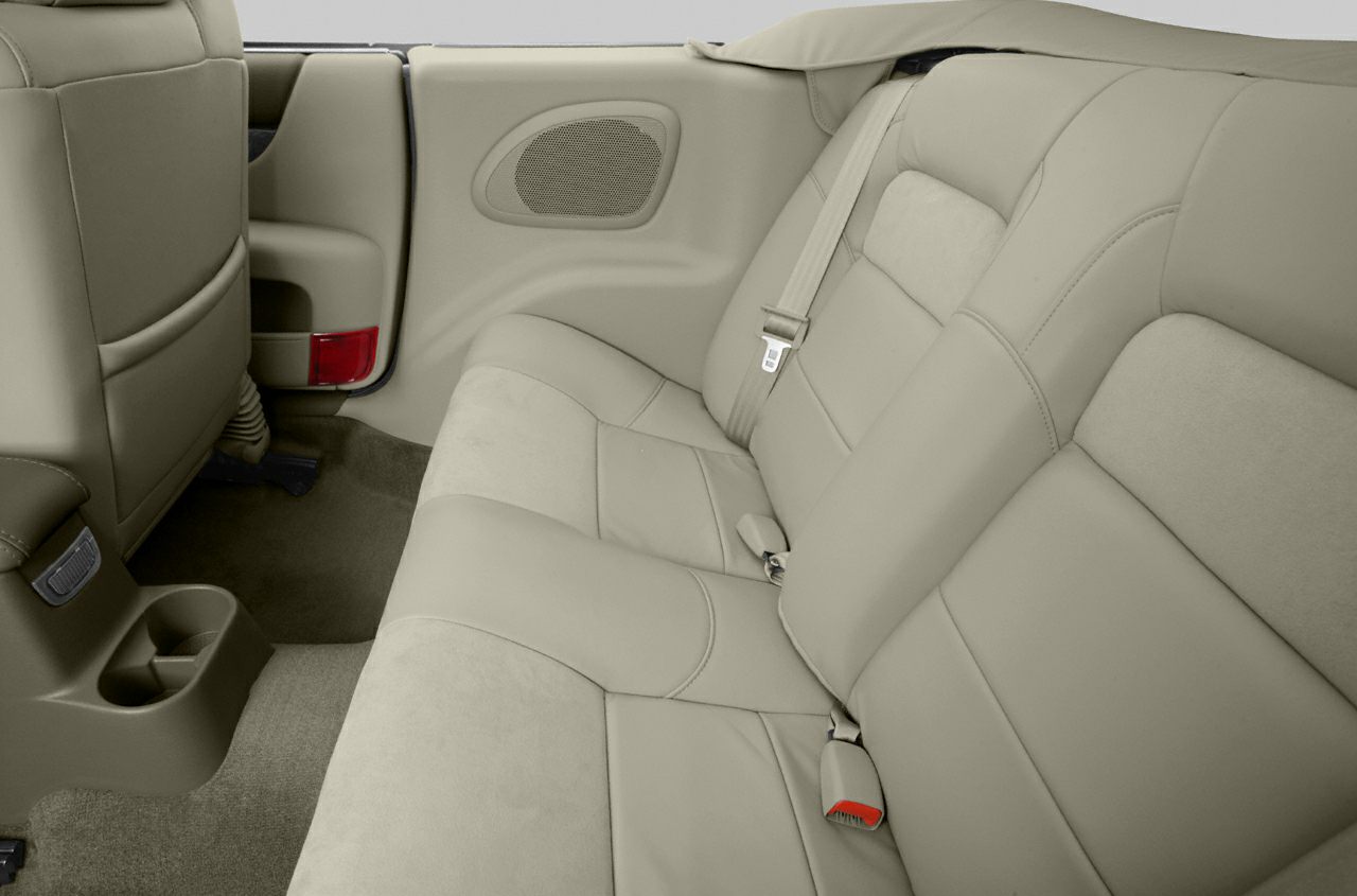 Rear leather seats with seatbelts and speaker panel in car interior