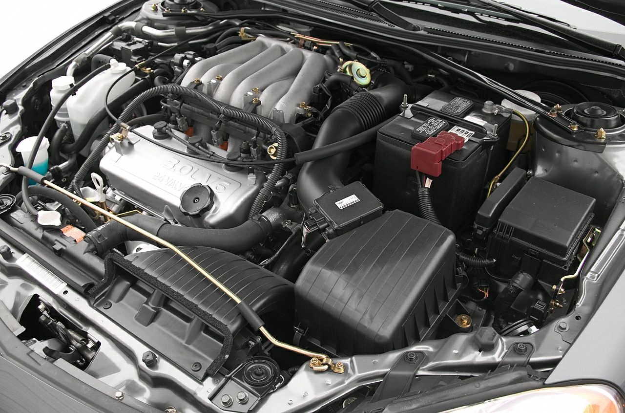3.0L 24-valve V6 engine bay with intake, air filter, and battery