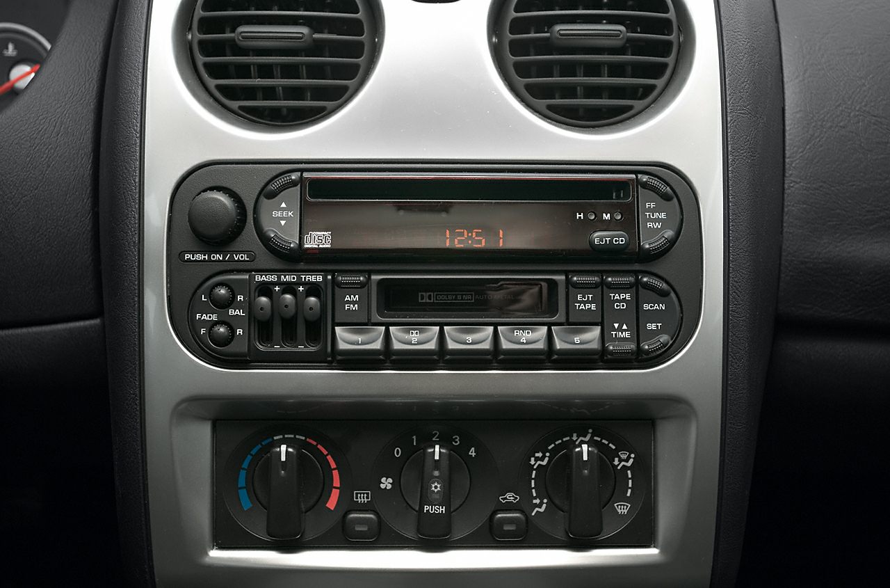 Vintage car stereo and climate control knobs in dashboard