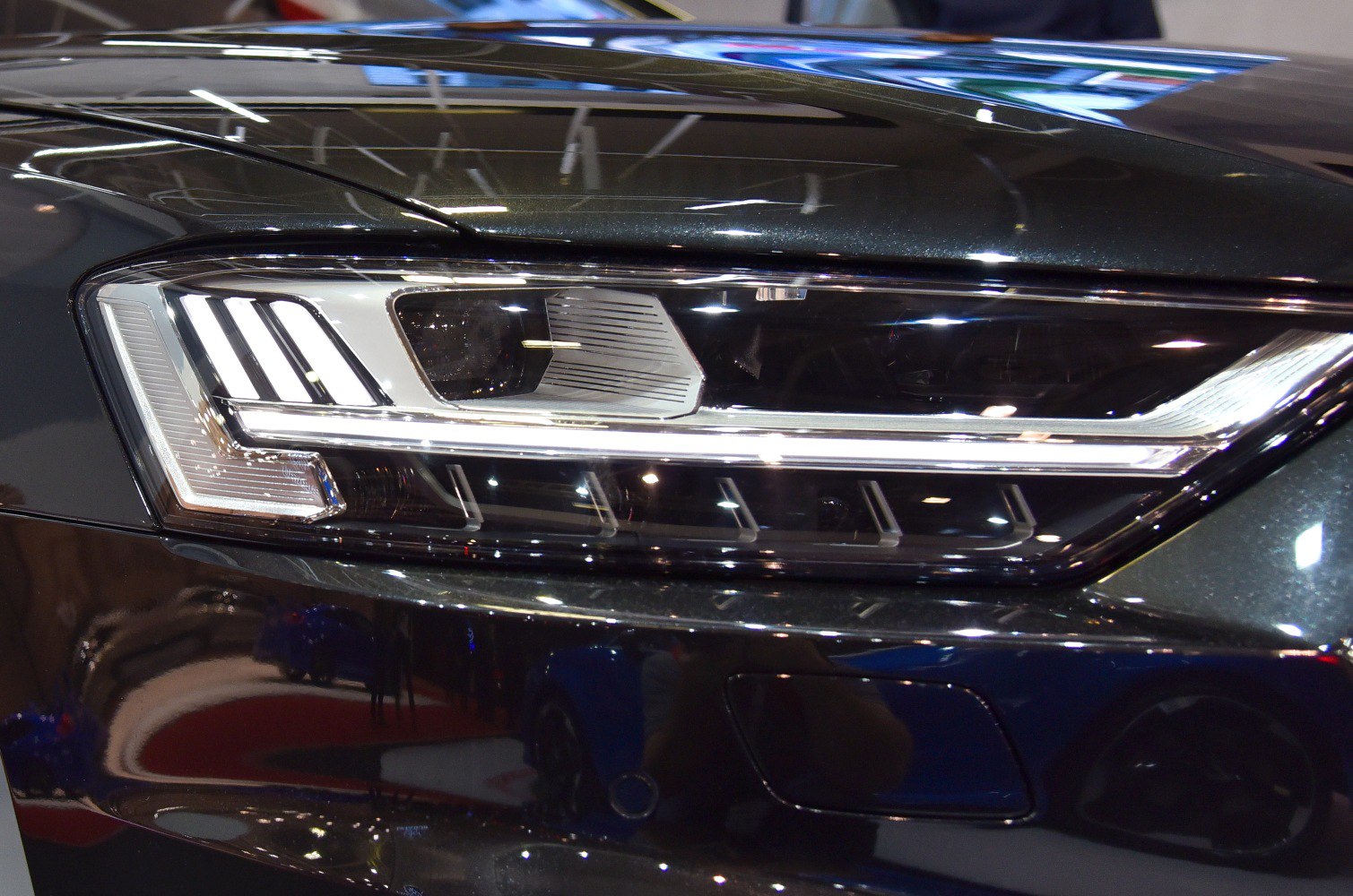 Close-up of a modern LED headlight with intricate design details.