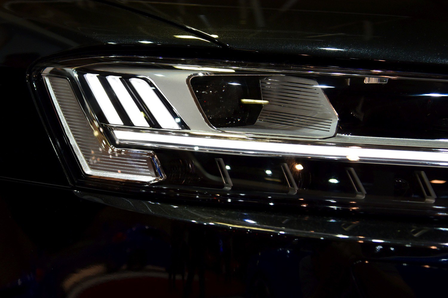 Close-up of a car's LED headlight with distinct vertical light segments