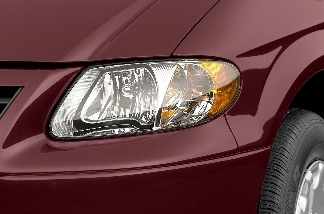 Close-up of a front headlight with integrated turn signal on vehicle body.