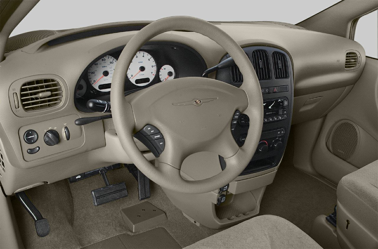 Beige dashboard and steering wheel with controls and instrument cluster