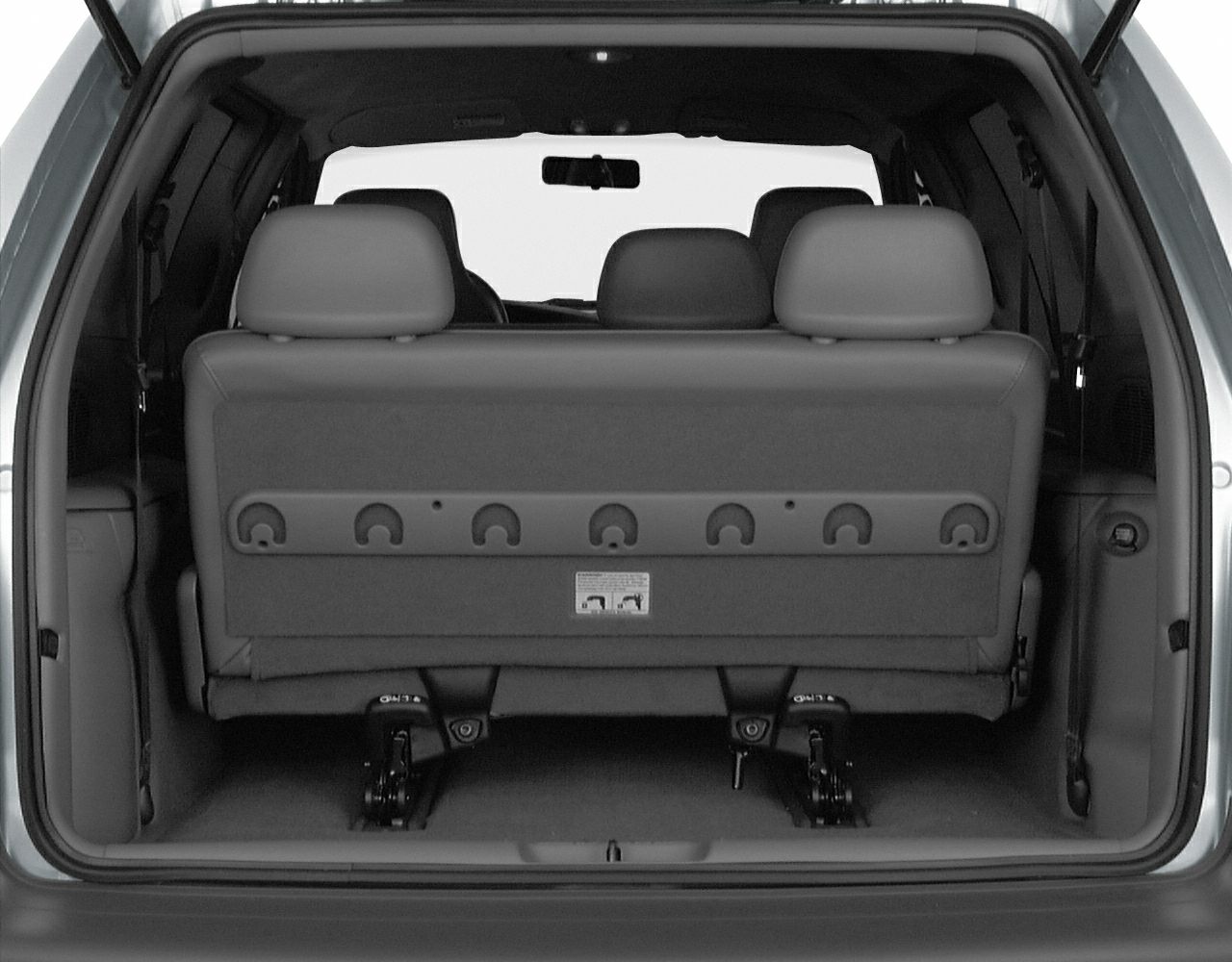 Foldable rear seats and spacious rear interior of a minivan.