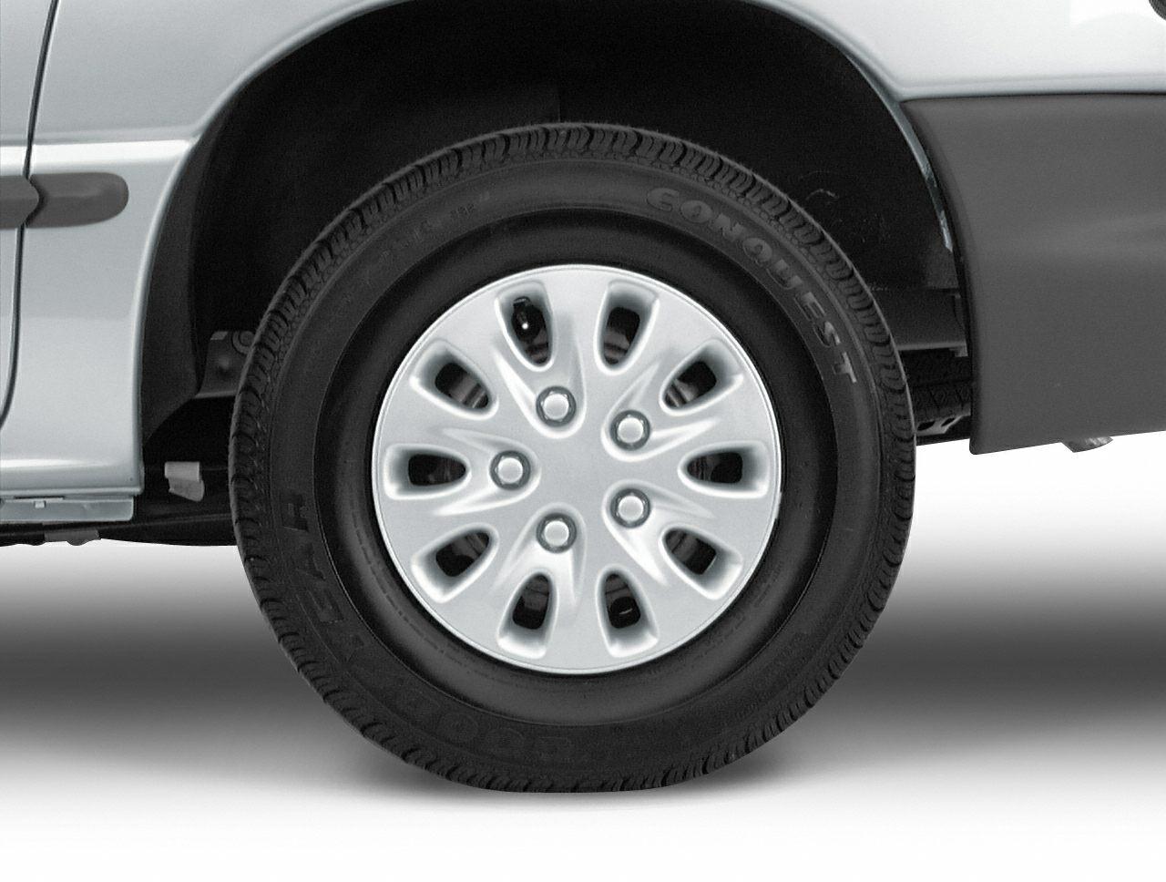 Close-up of steel wheel rim and tire on vintage minivan