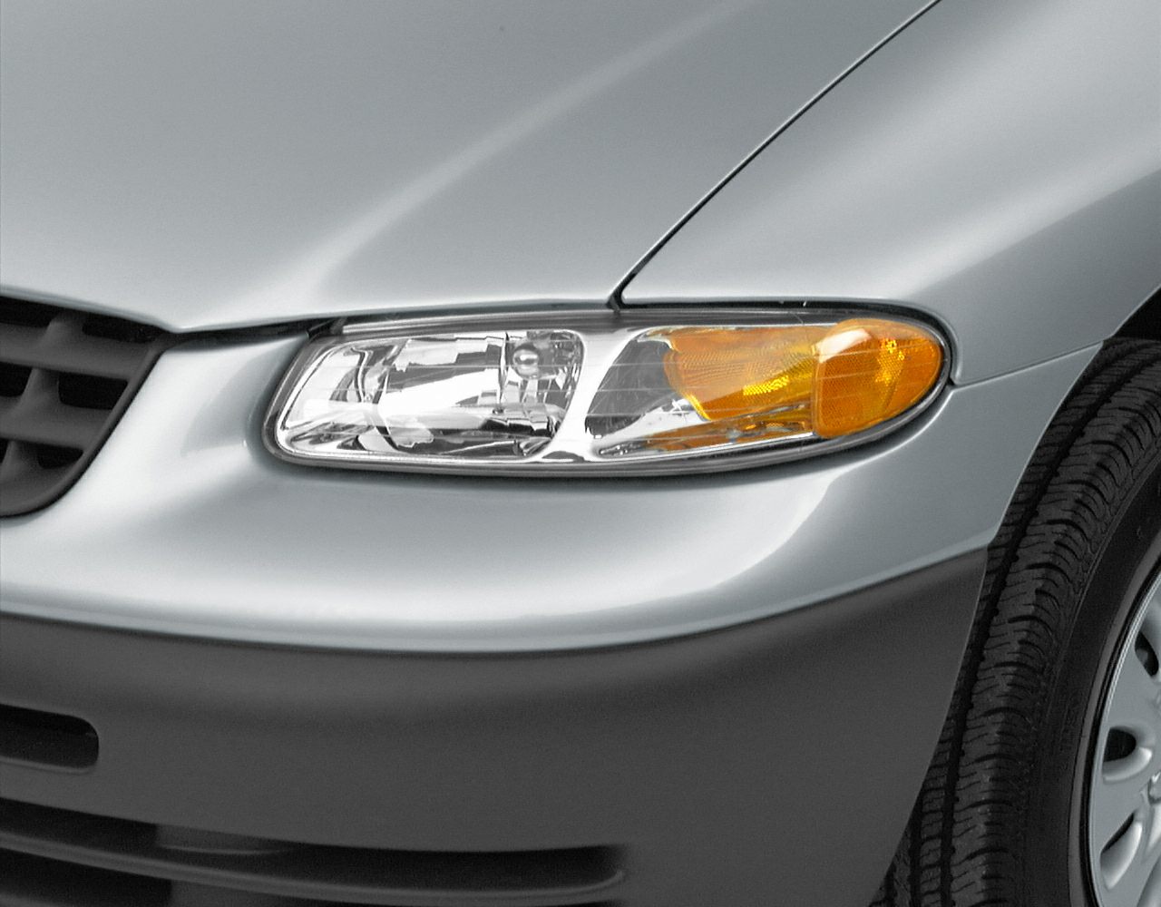Close-up of headlight and front fender with tire