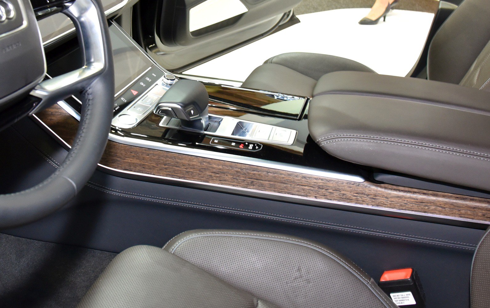 Luxury center console with wood trim and modern gear shifter close-up