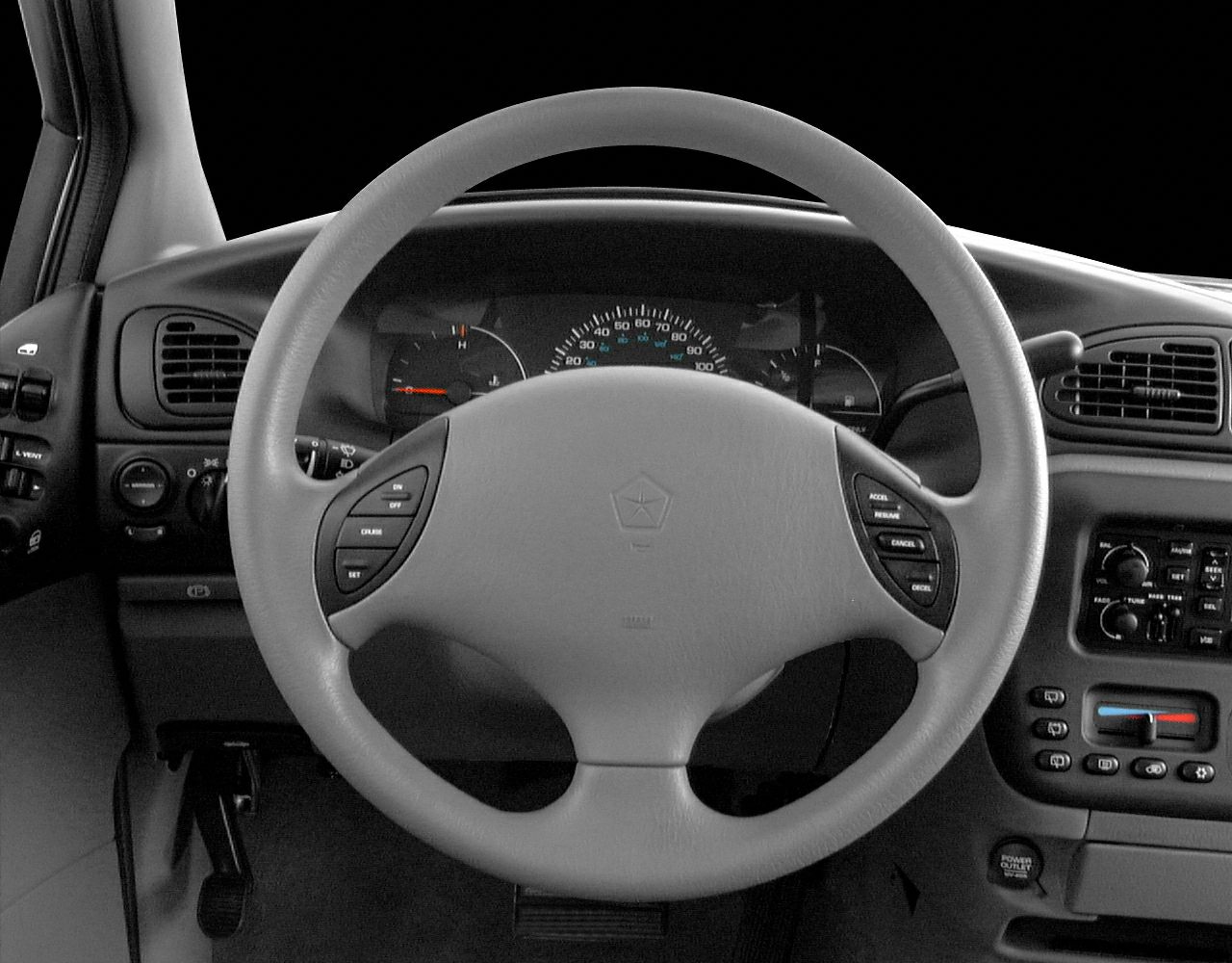 Steering wheel with cruise control buttons and dashboard instrument cluster