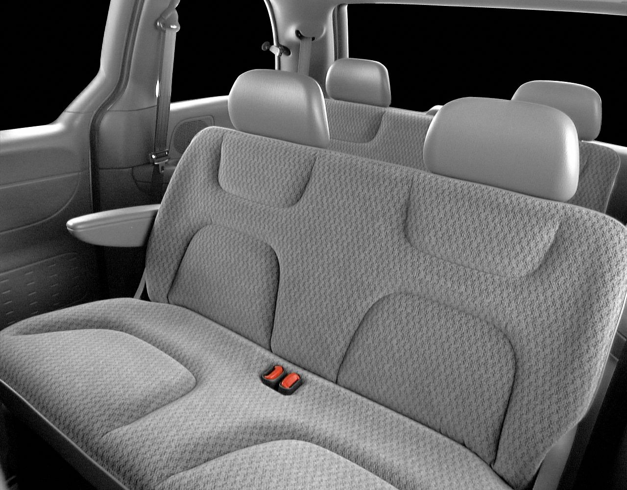 Rear bench seats with fabric upholstery featuring built-in headrests and fold-down armrest.