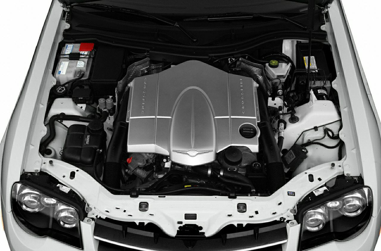 Car engine bay with engine cover and visible components