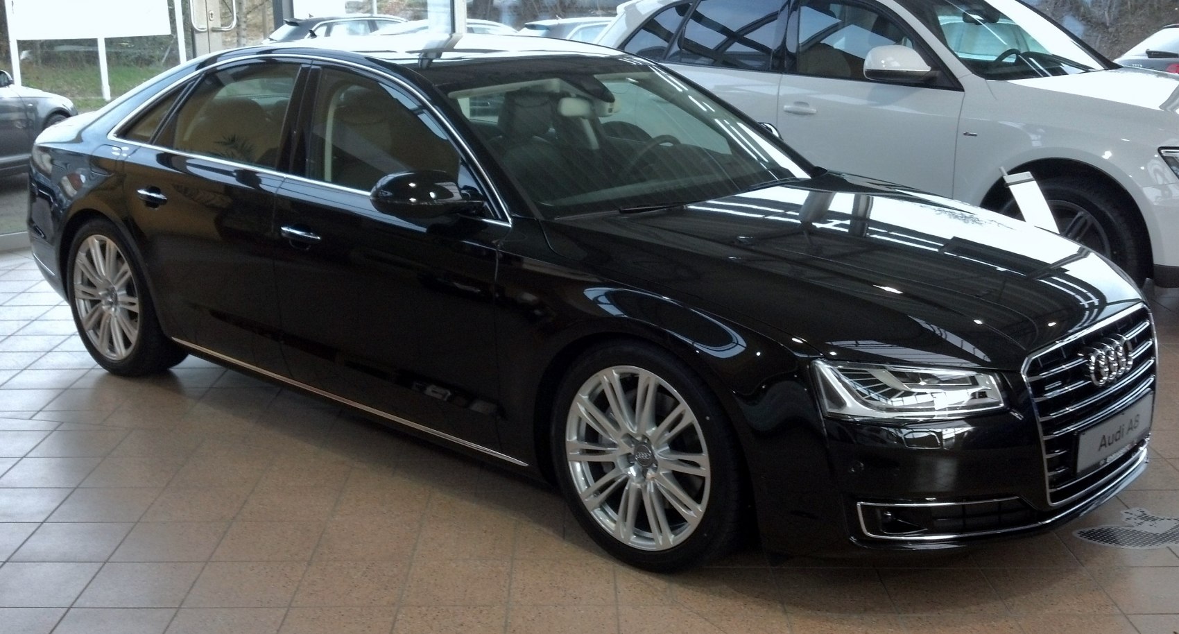 Luxury sedan with sharp LED headlights and alloy wheels, front side view