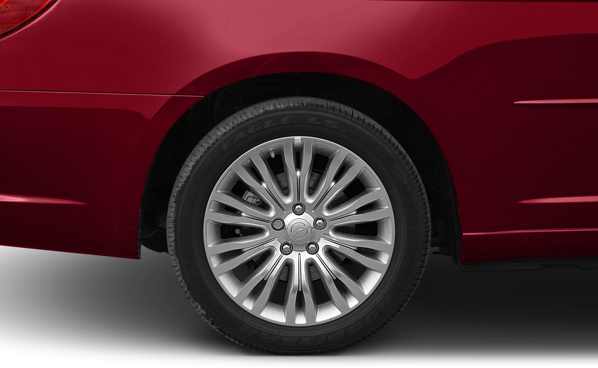 Multi-spoke alloy wheel and Goodyear tire on red vehicle panel