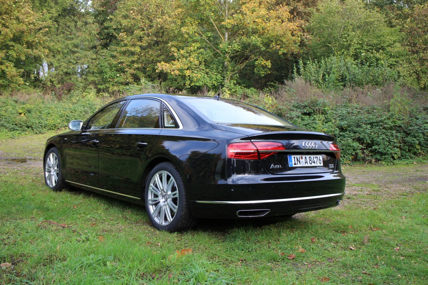 Luxury sedan rear view with LED tail lights and dual chrome exhaust outlets