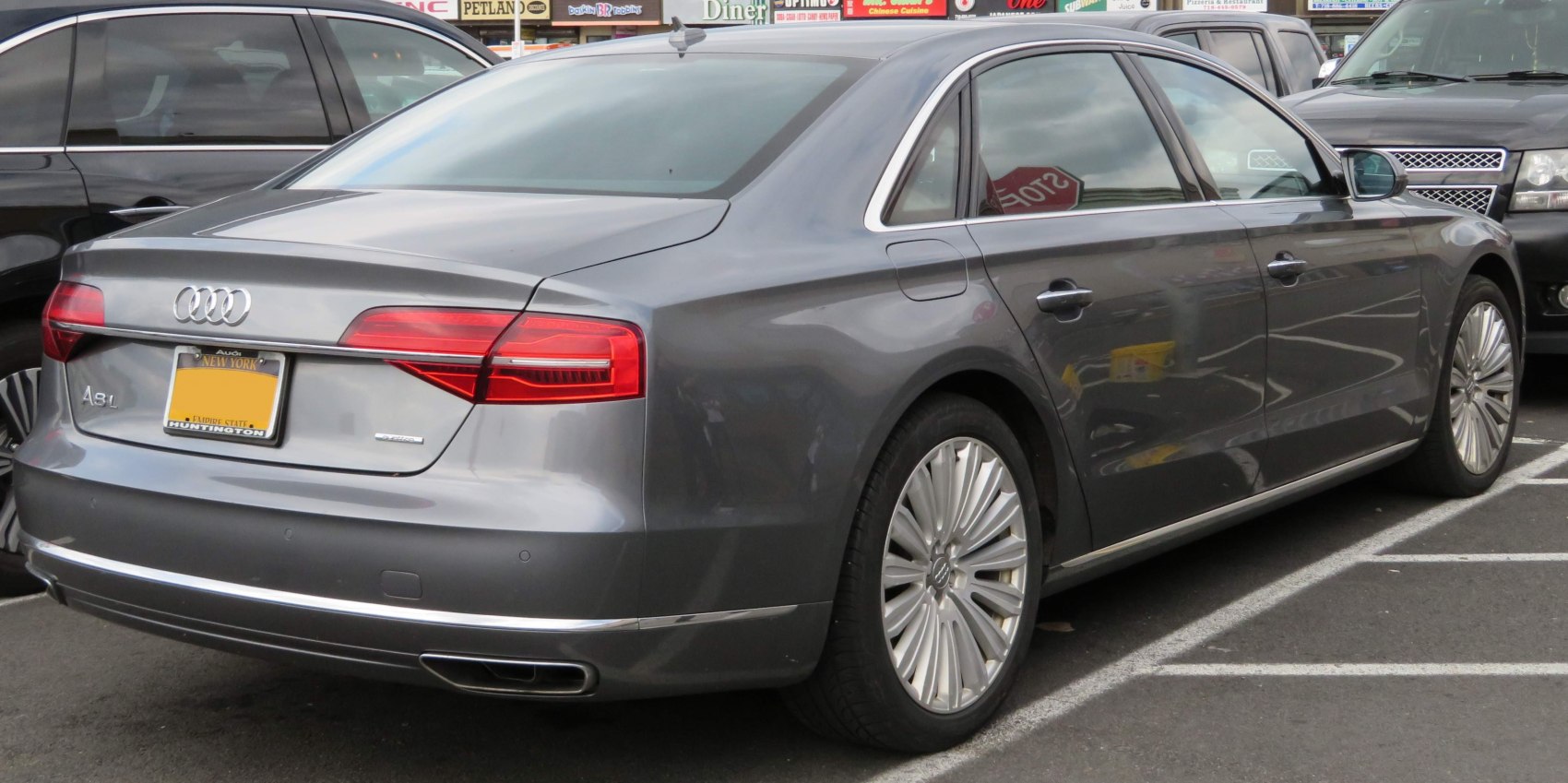 Luxury sedan rear with LED taillights and chrome trim