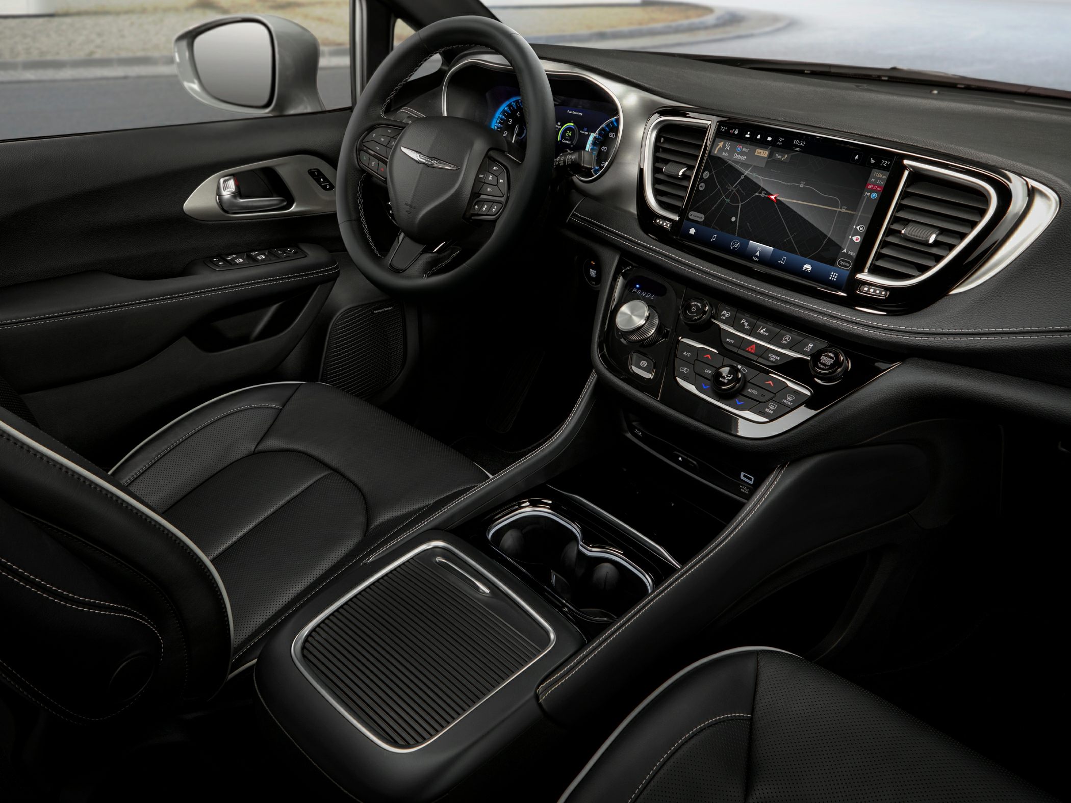 Modern minivan interior with digital cluster, touchscreen, and leather seats