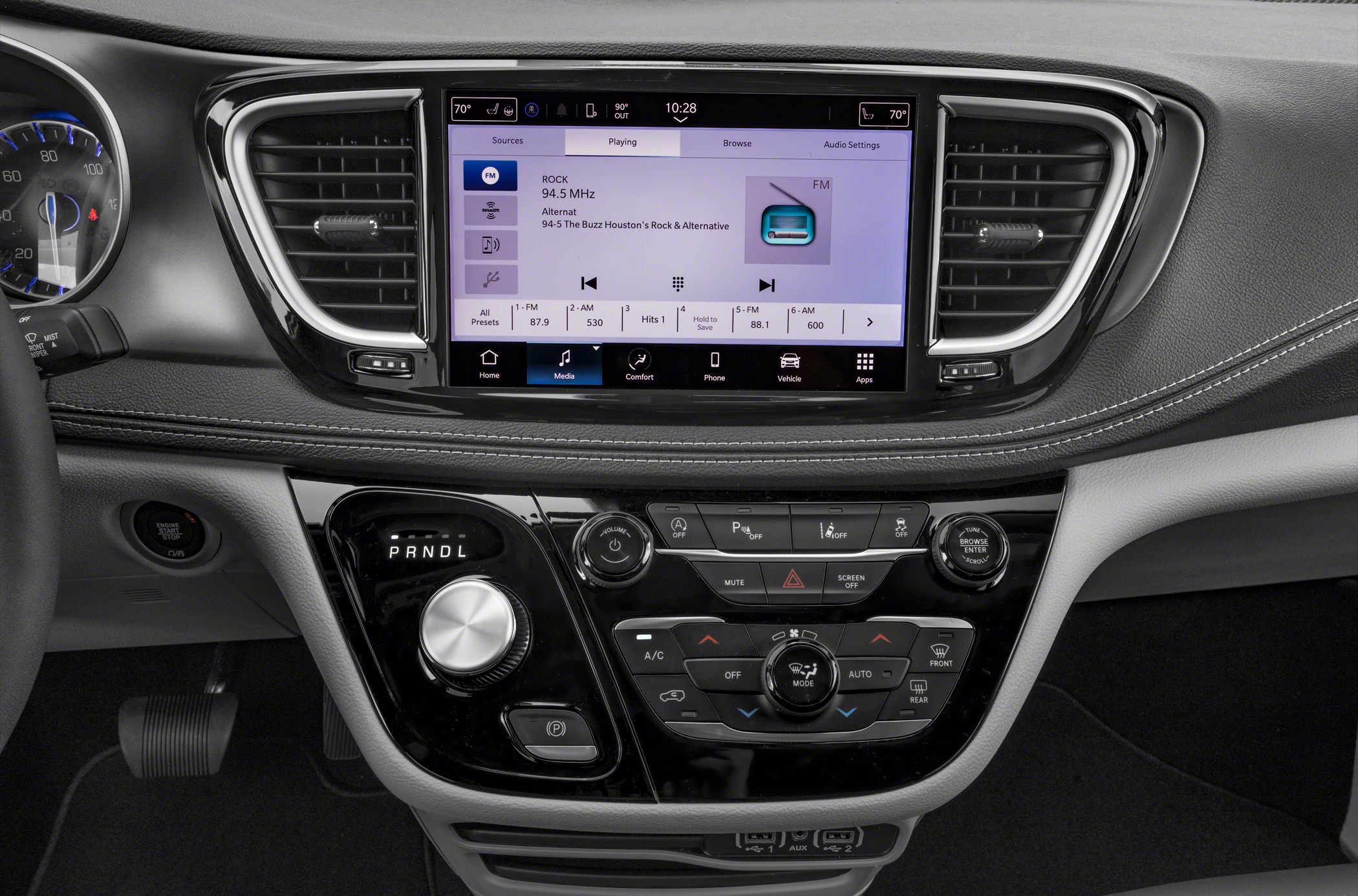Touchscreen infotainment and rotary gear selector in vehicle dashboard