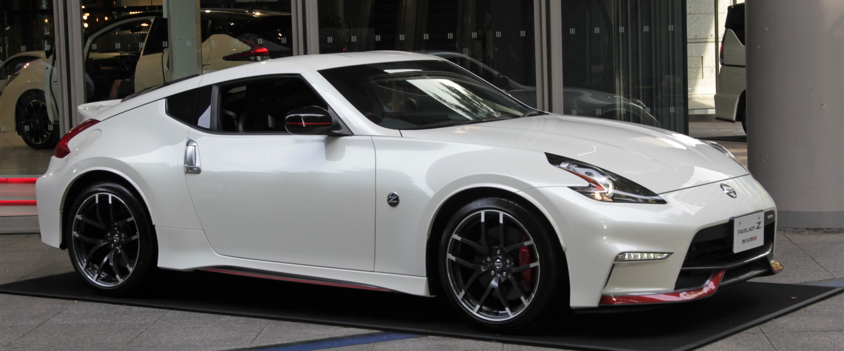 Sleek white sports coupe with LED headlights and alloy wheels