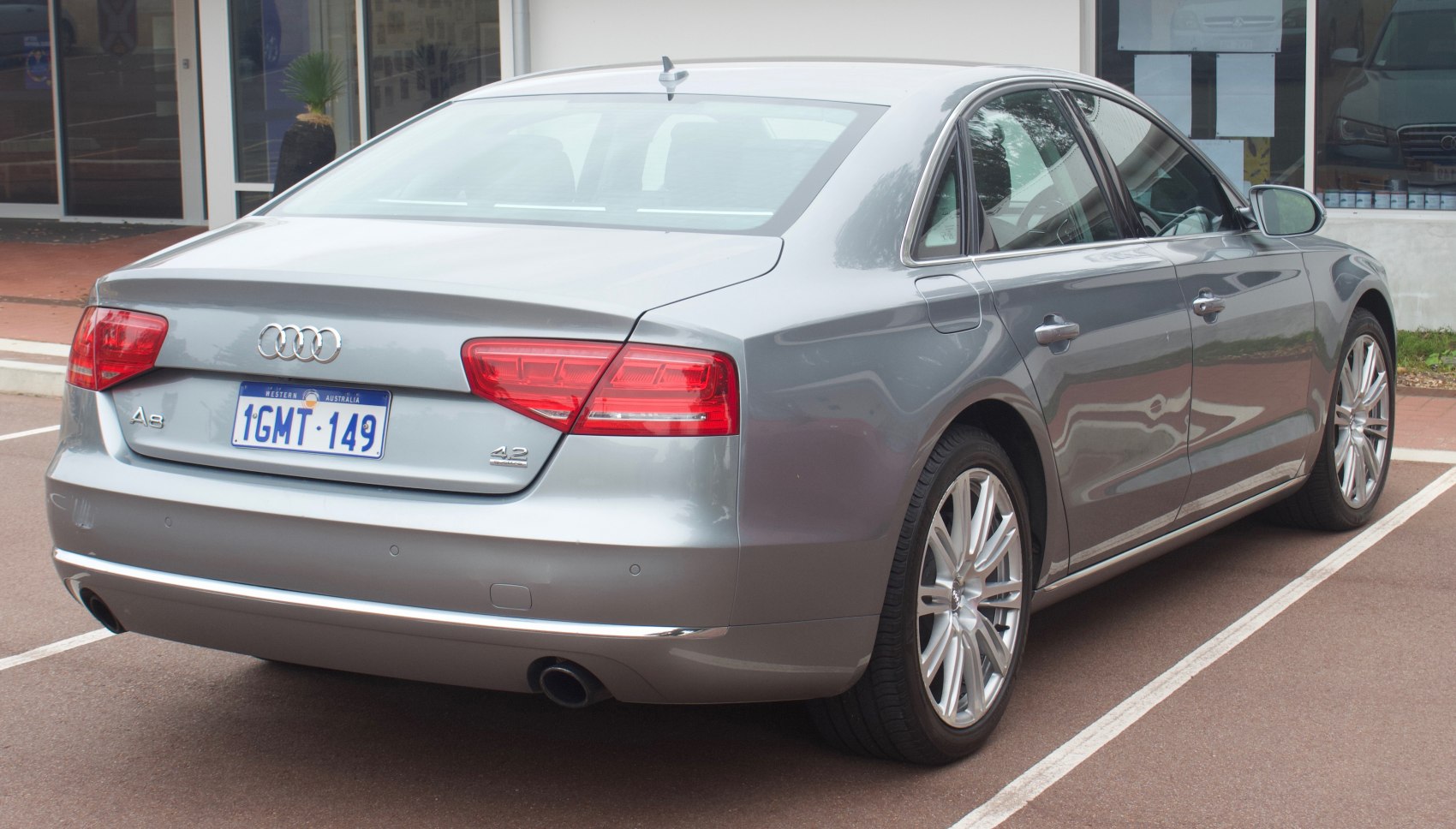 Silver luxury sedan rear and side view with taillights and alloy wheels