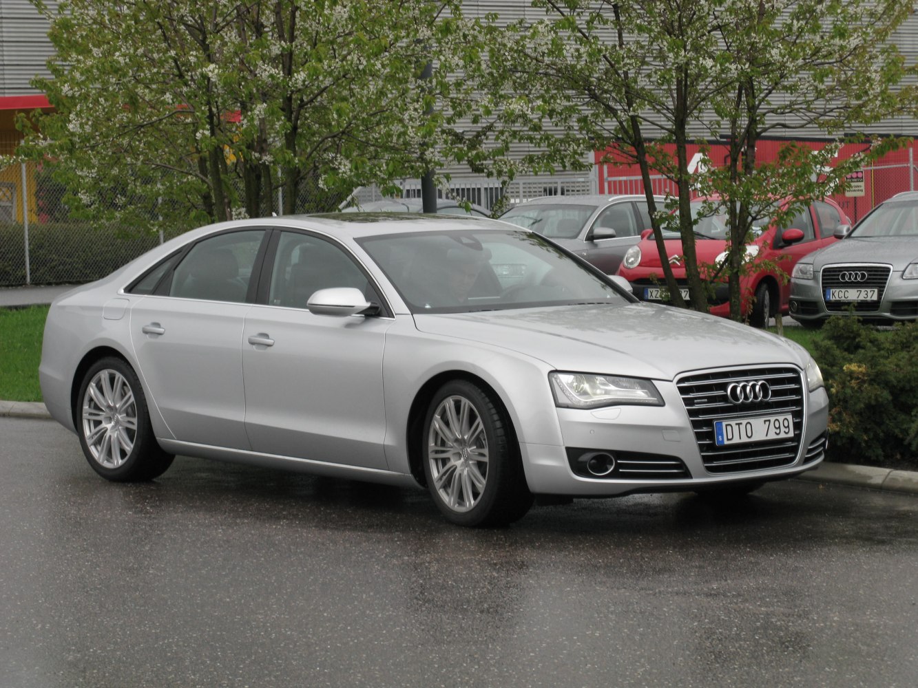 Silver luxury sedan front-side view with LED headlights and distinctive grille