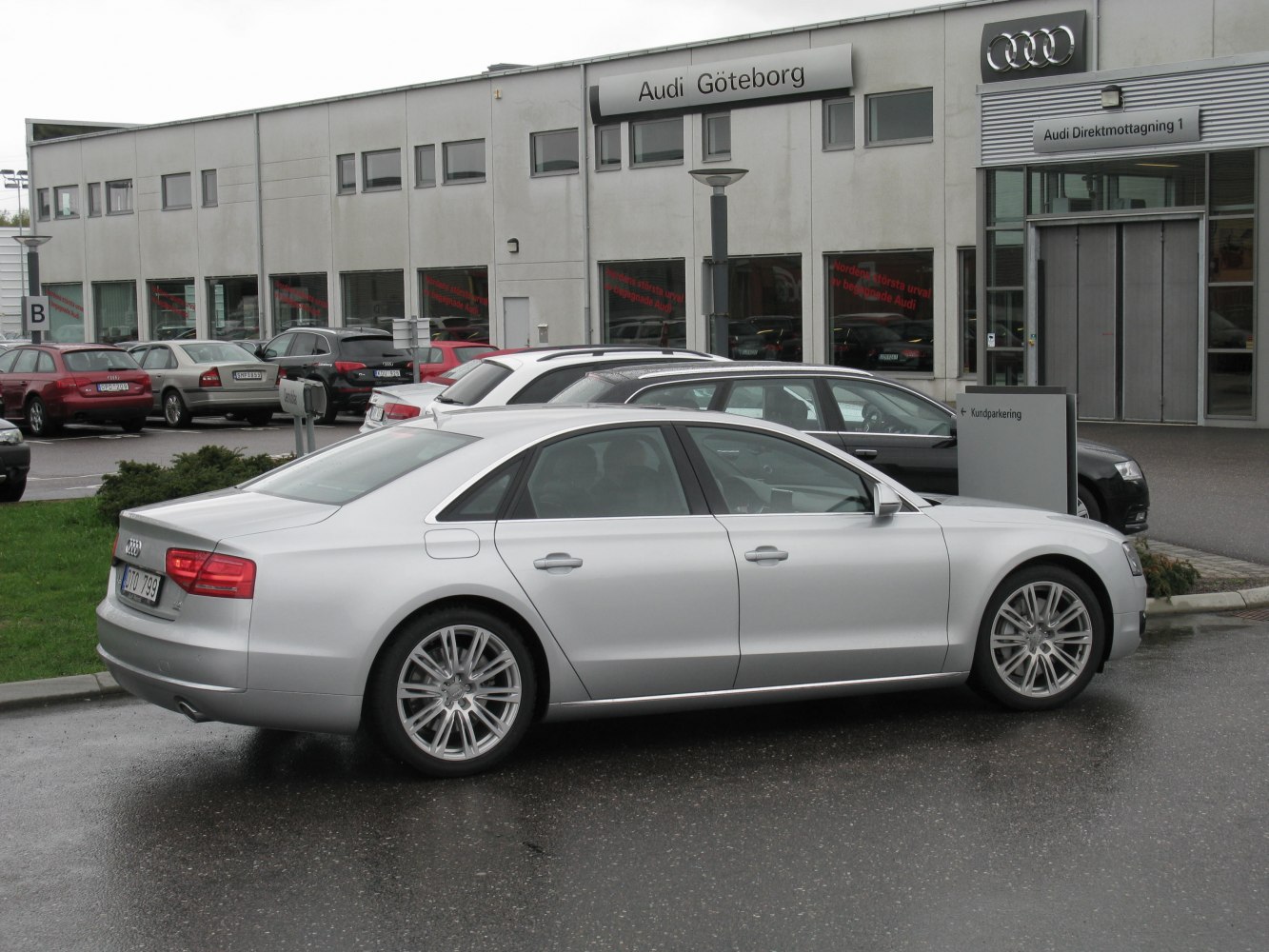 Silver luxury sedan side profile with alloy wheels and sleek design