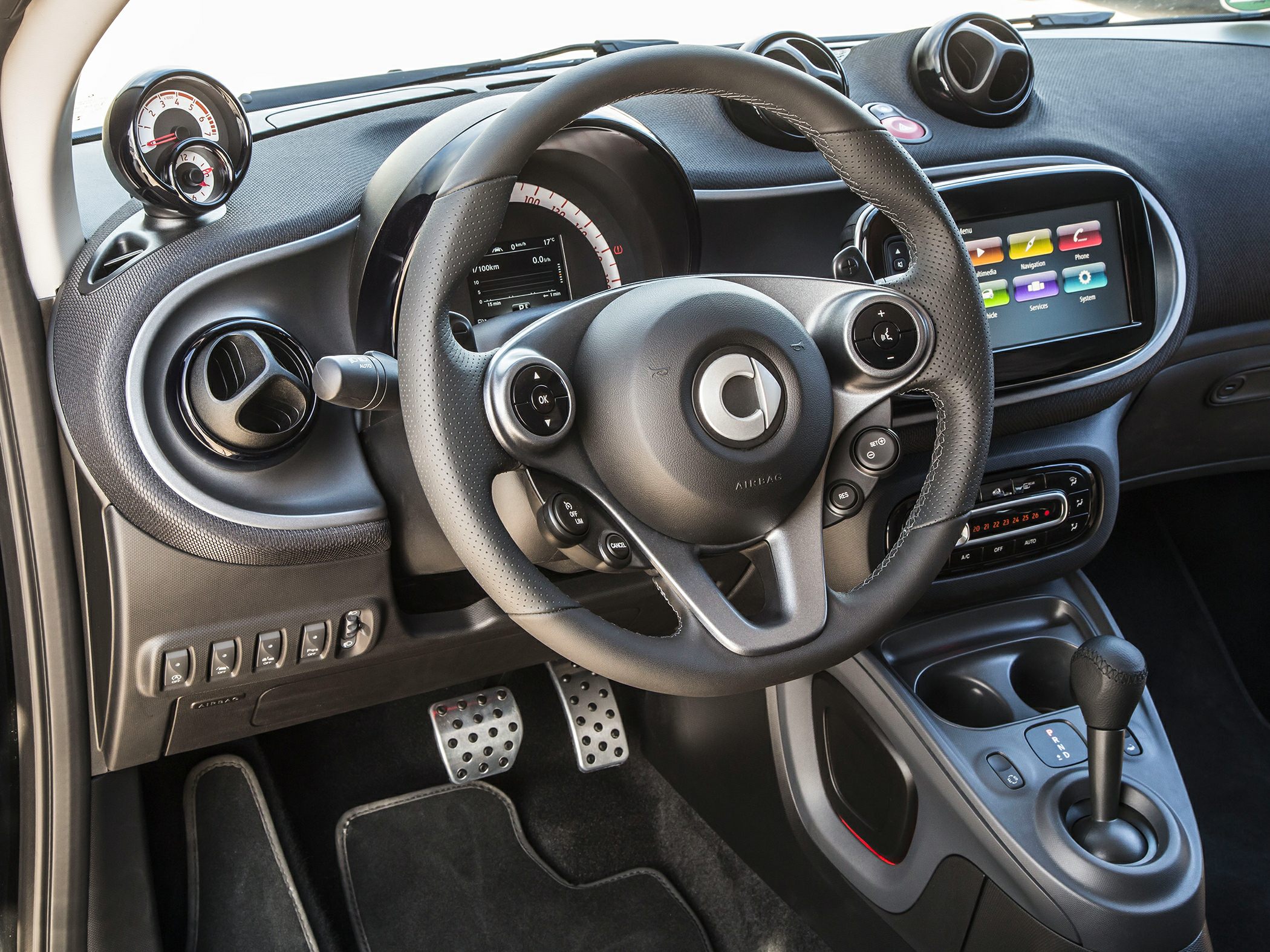 Steering wheel, dashboard with digital displays, and center console with gear shifter