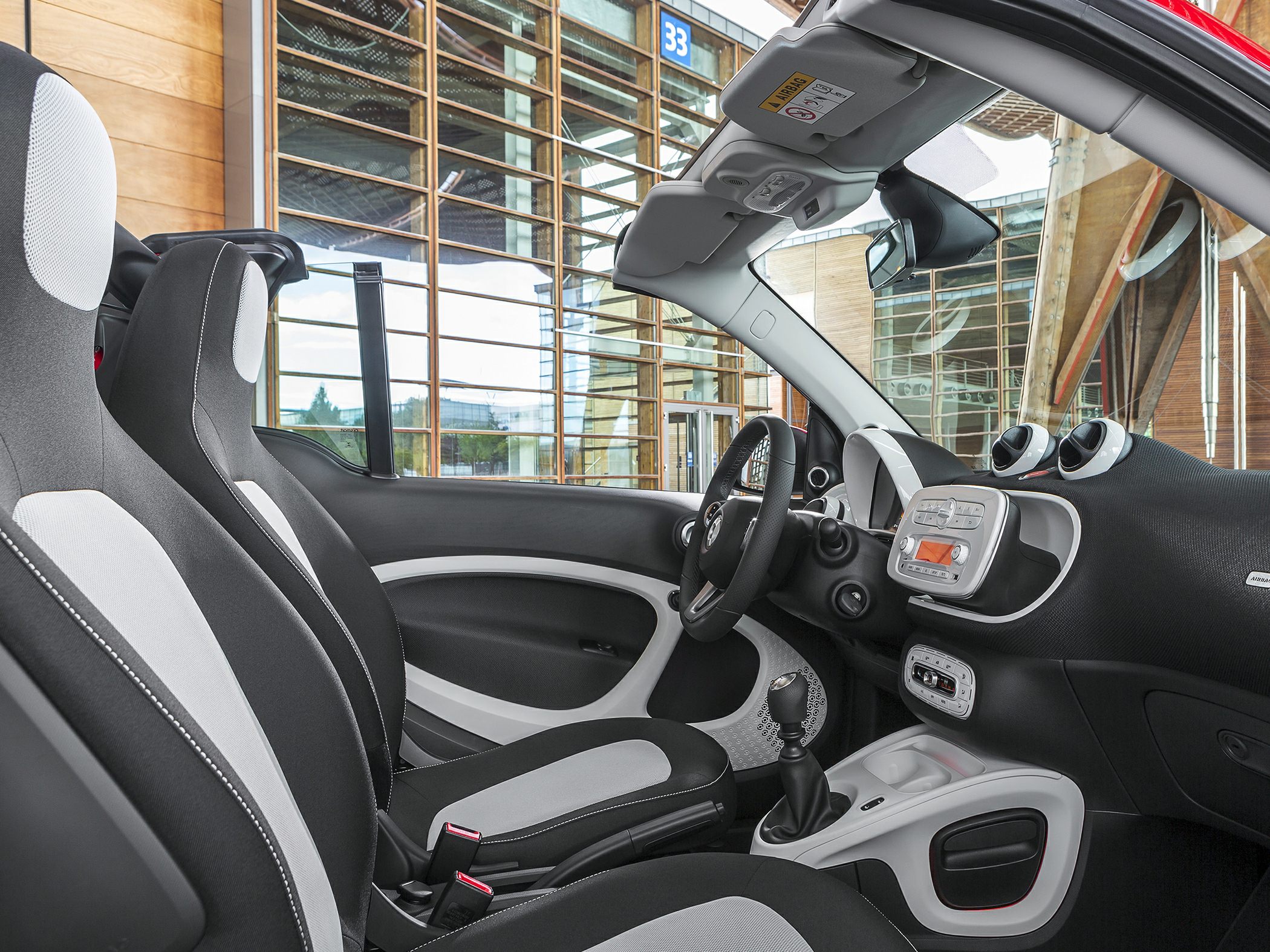 Modern compact interior with sporty seats and manual gearstick