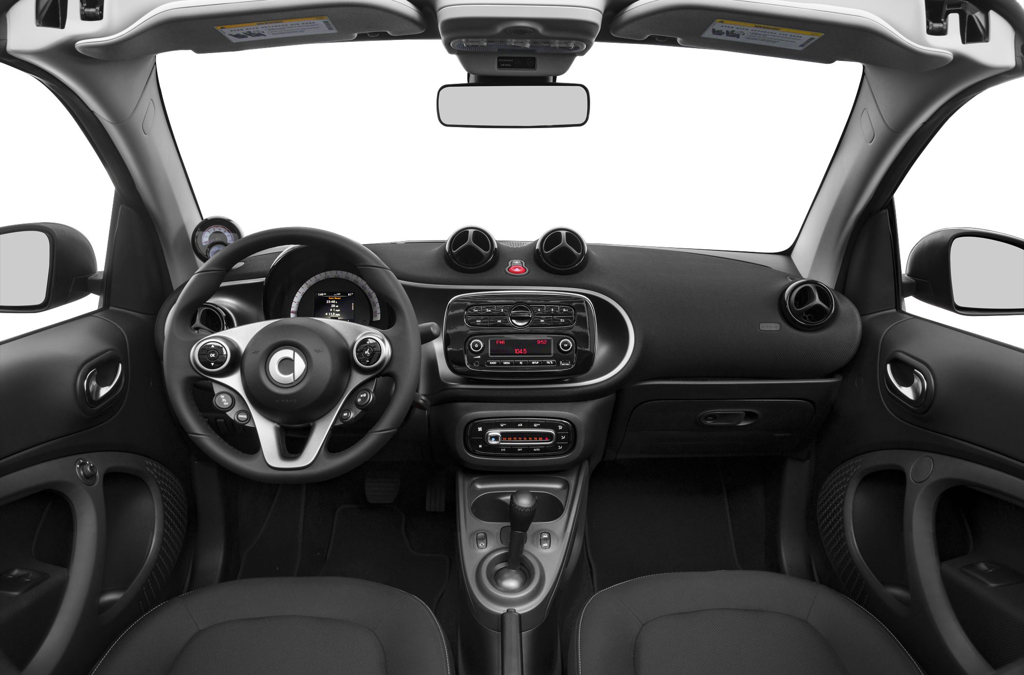 Compact car interior with steering wheel, dashboard controls, and gear shift.