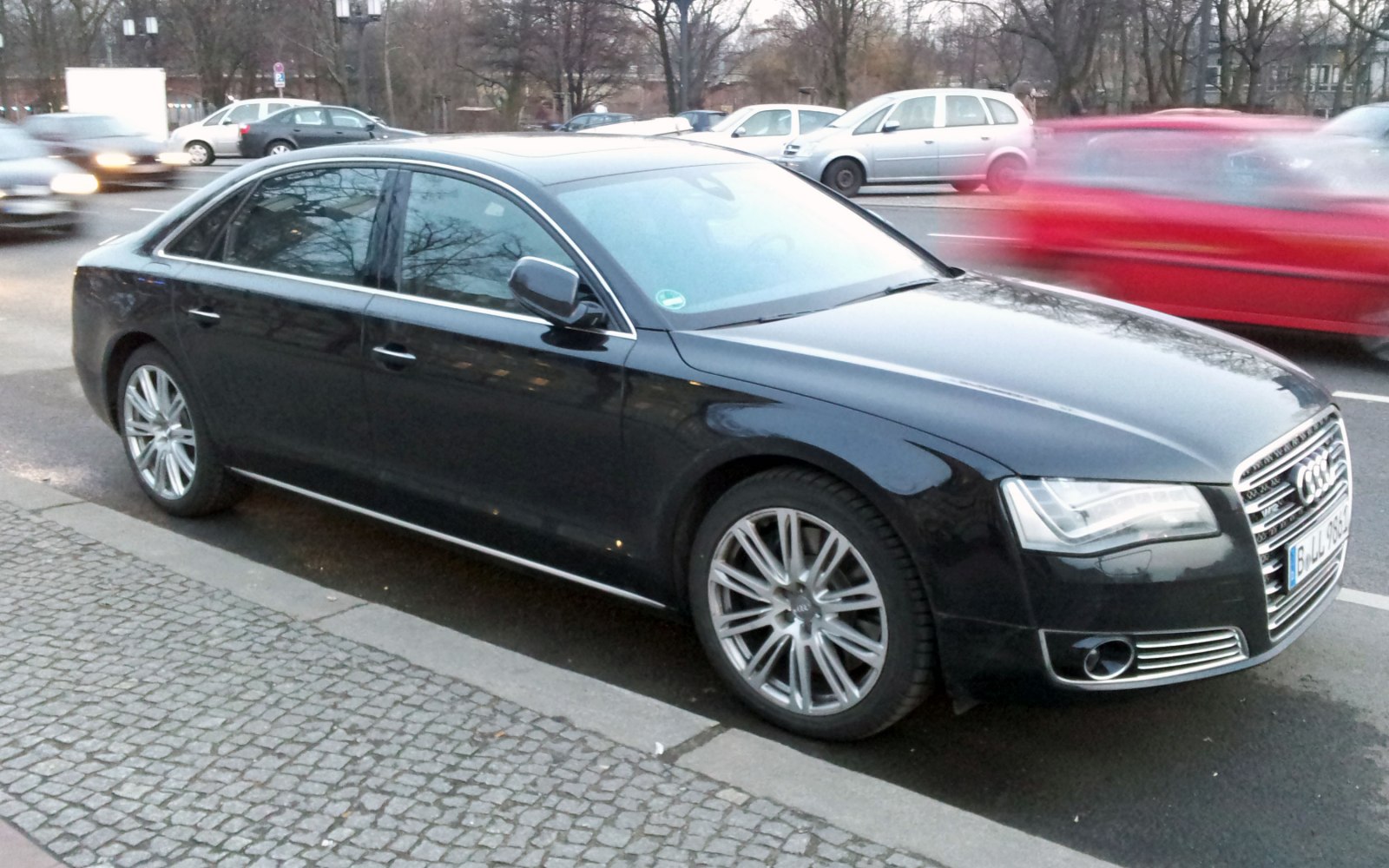 Black luxury sedan with alloy wheels and aerodynamic body