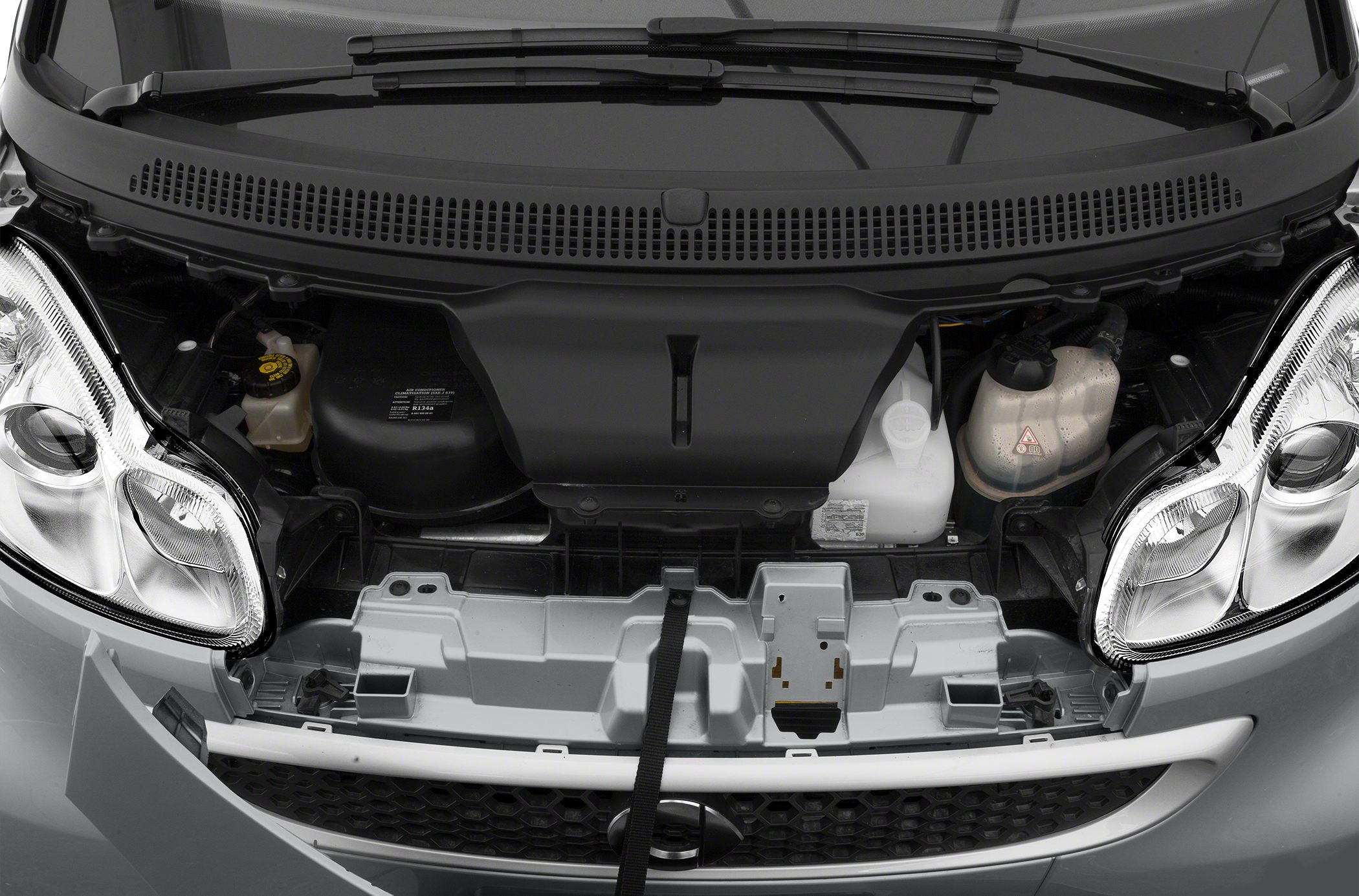Engine bay and front headlights of compact vehicle