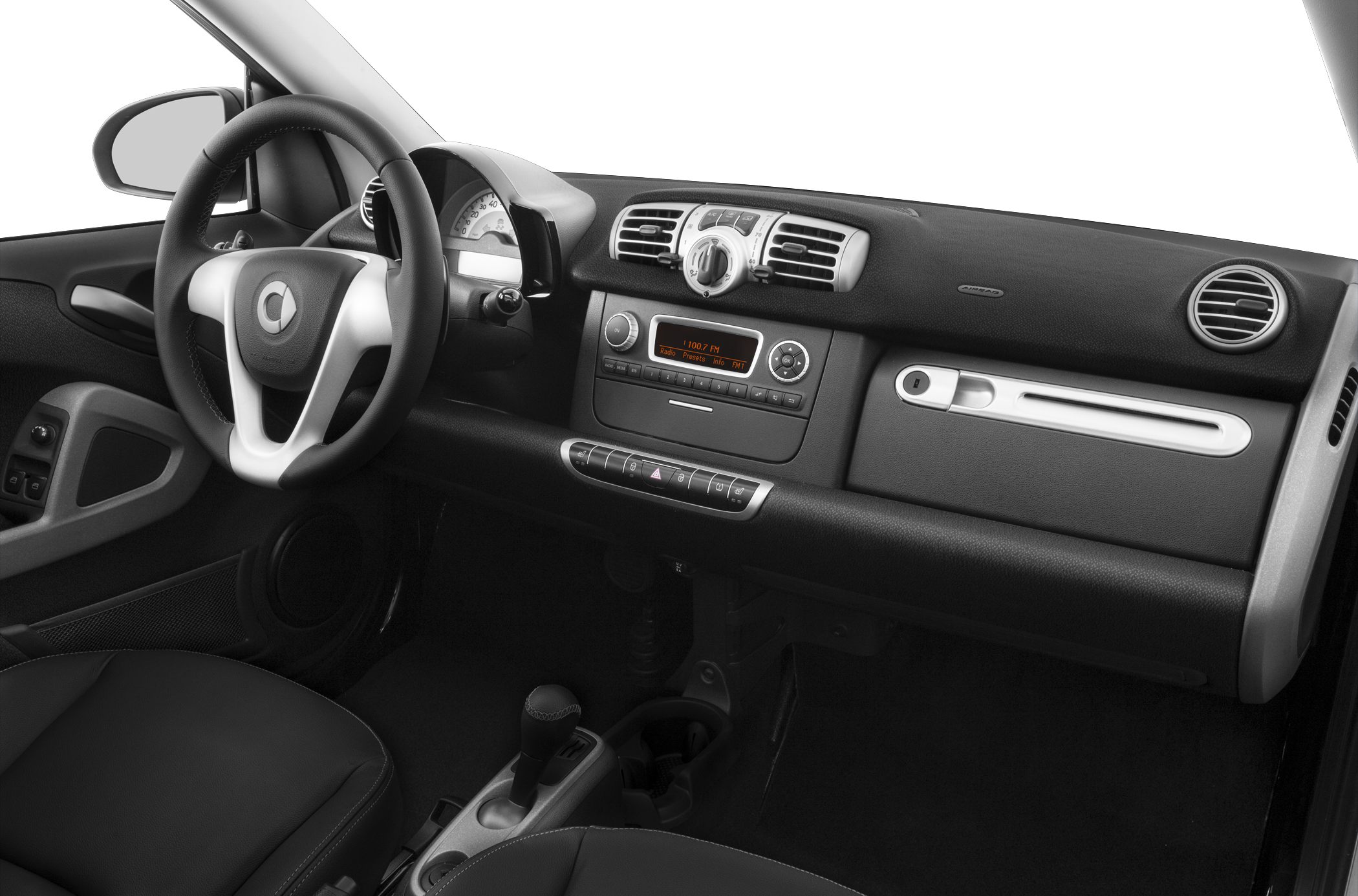 Compact dashboard and steering wheel with air vents and radio controls