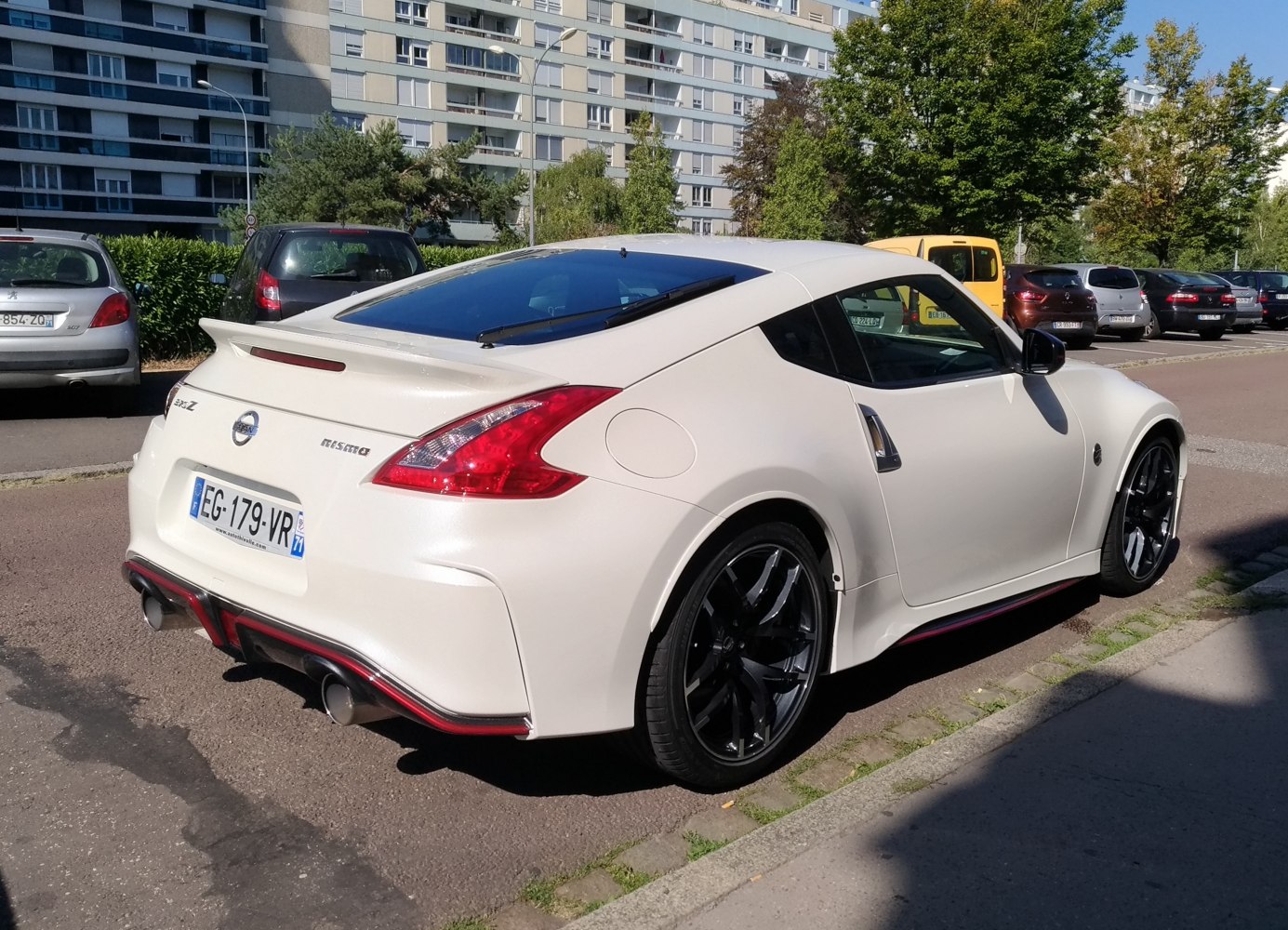 Rear view of white sporty coupe with rear spoiler and black alloy wheels