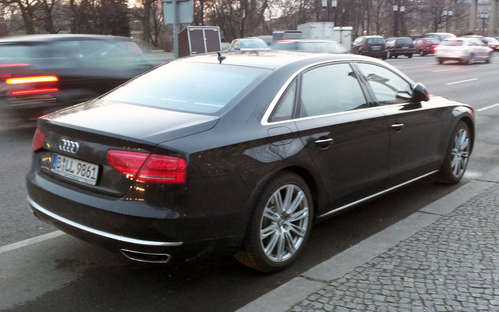 Luxury sedan rear side with chrome trim and alloy wheels