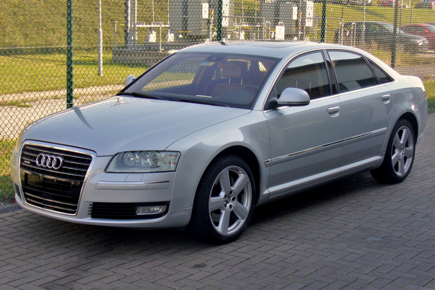 Silver sedan with chrome grille and LED headlights parked outdoors